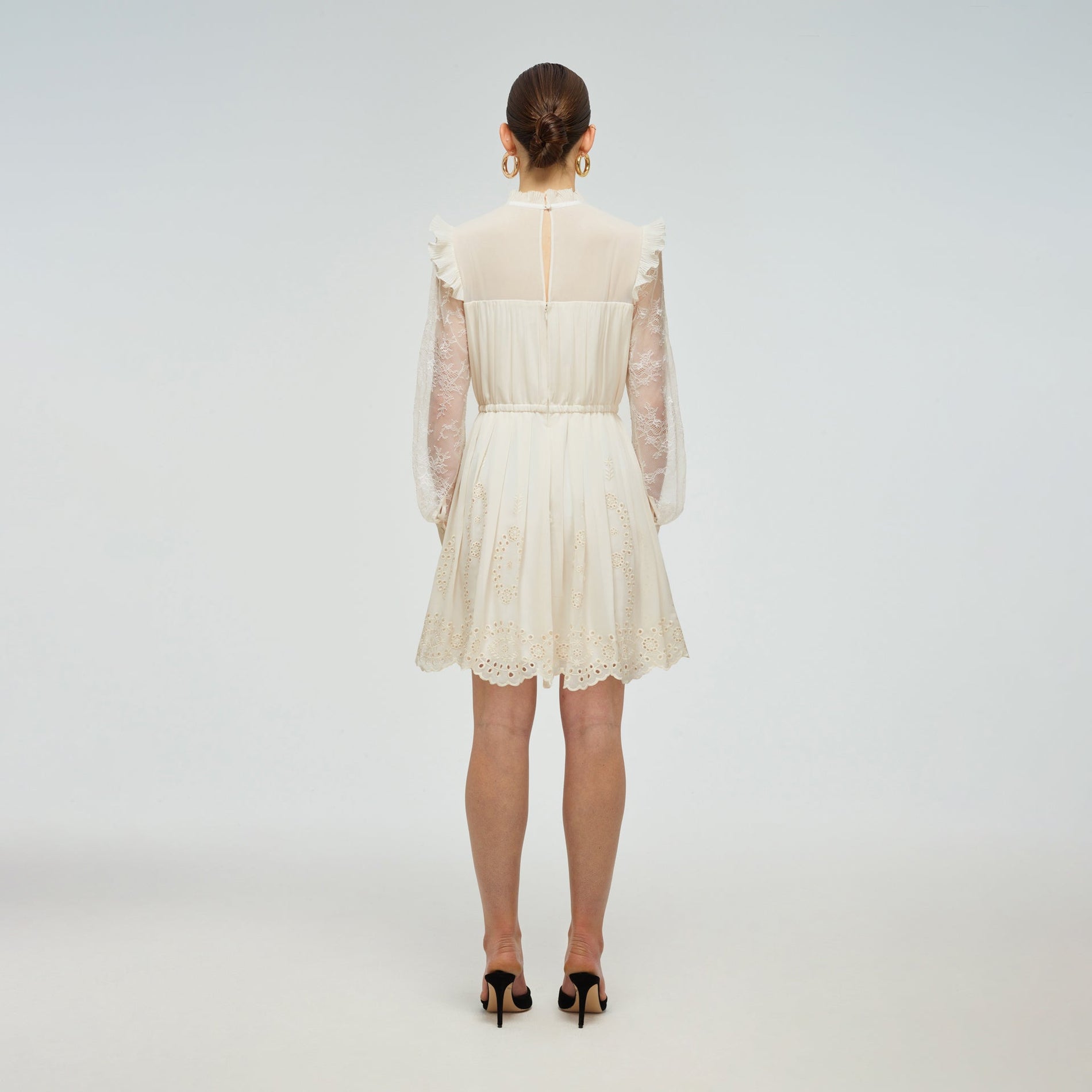 A woman wearing the Ivory Broderie Chiffon Dress