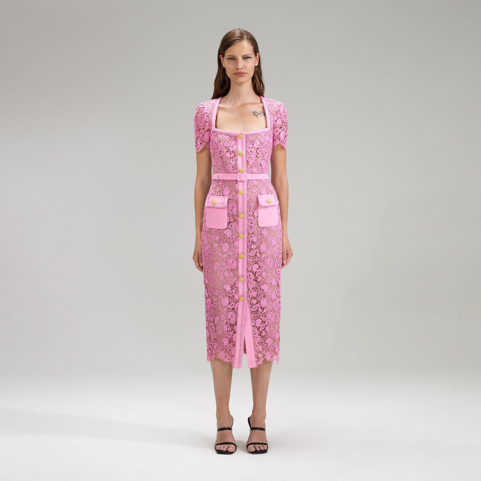 A woman wearing the Pink Guipure Lace Midi Dress