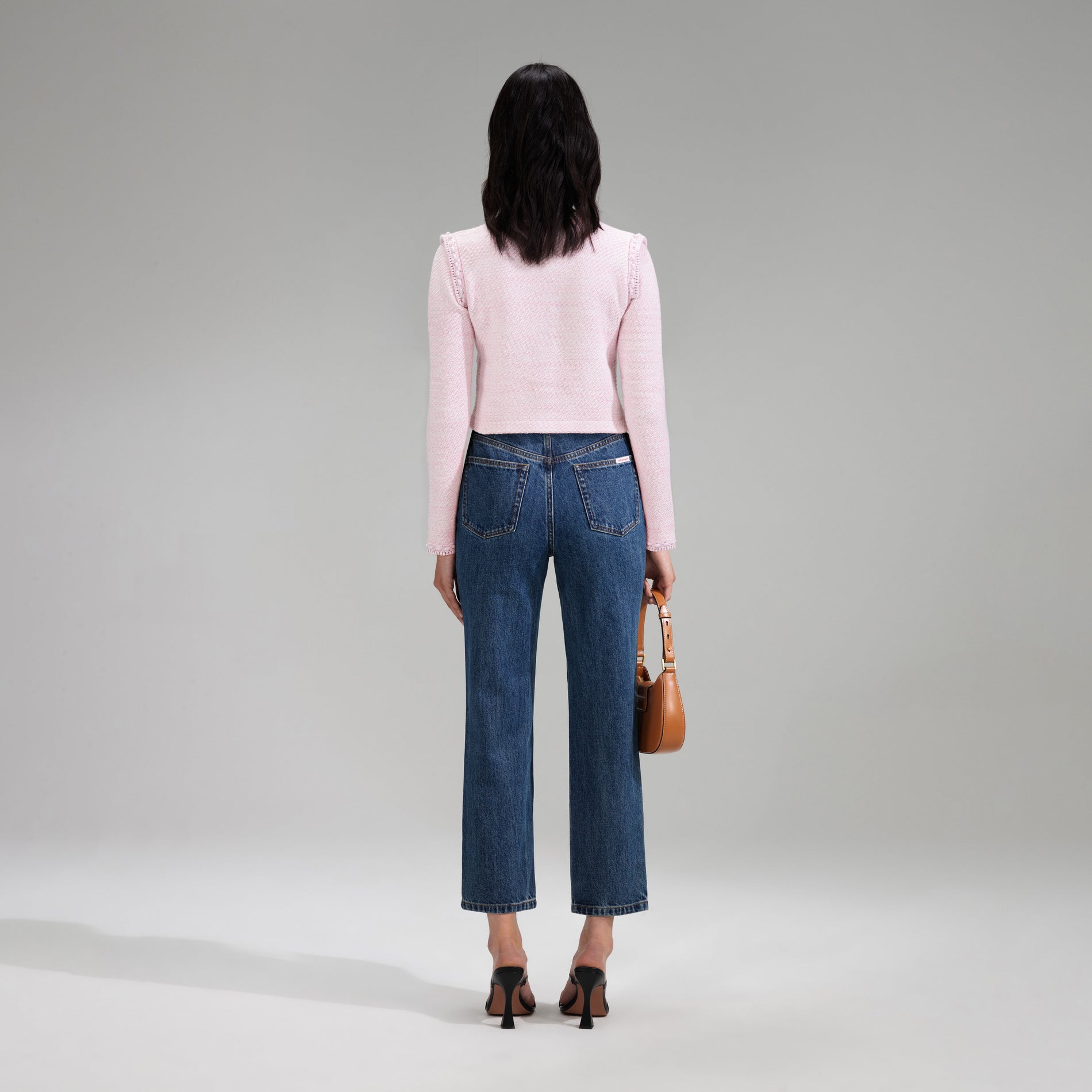 A woman wearing the Pink Knit Crop Cardigan