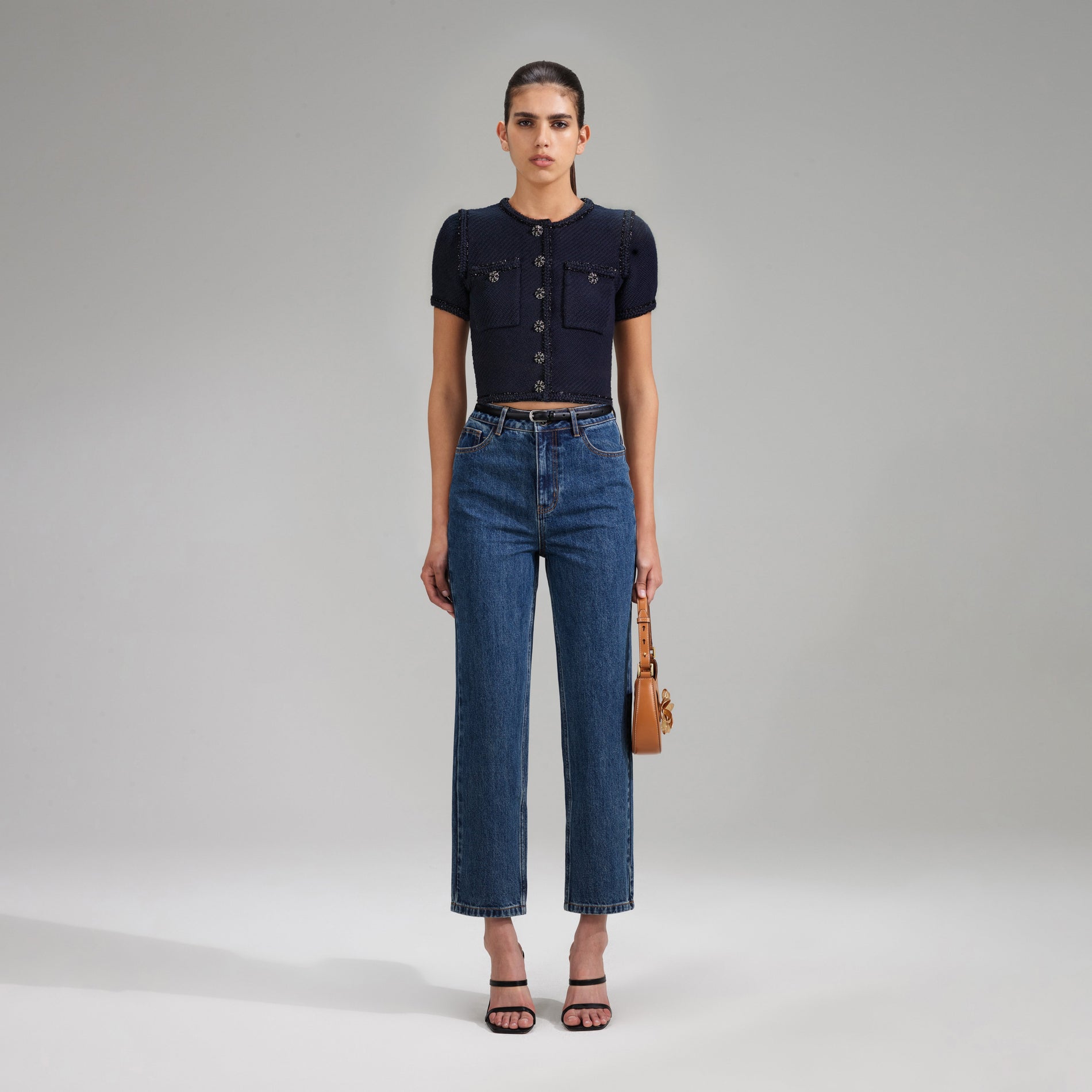 A woman wearing the Navy Knit Crop Cardigan