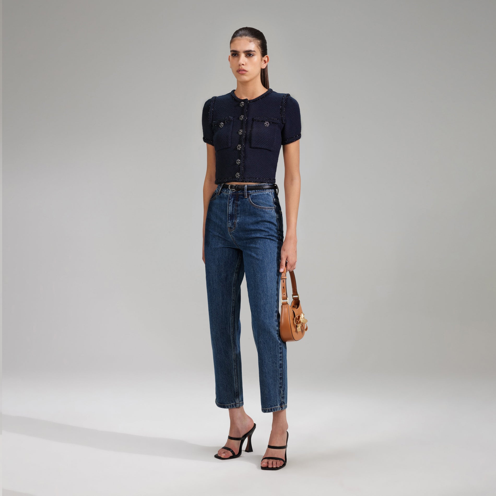 A woman wearing the Navy Knit Crop Cardigan