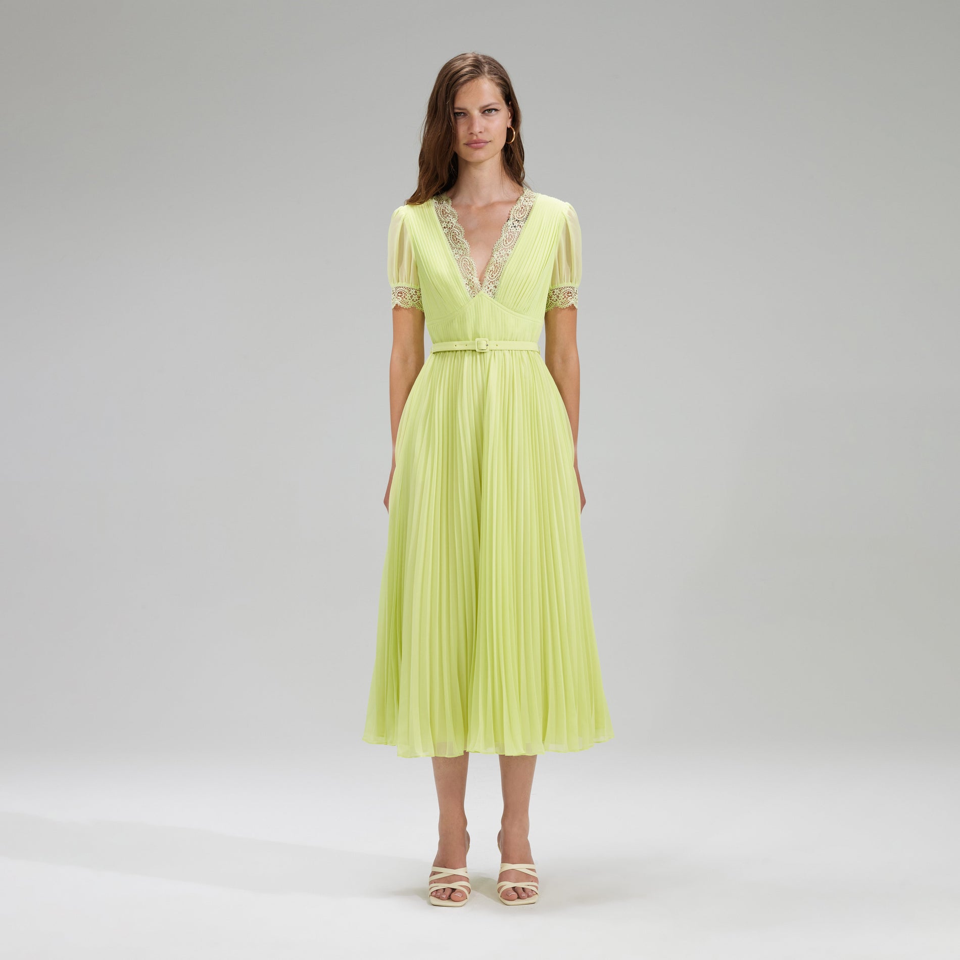 A woman wearing the Lime Chiffon Midi Dress Lace Detail