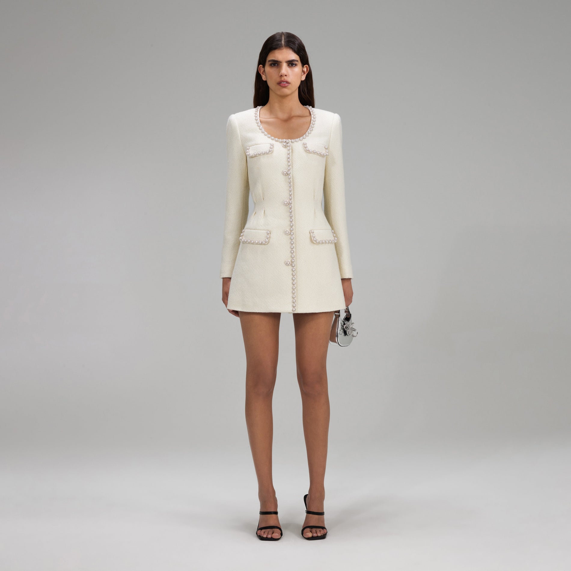 A woman wearing the Cream Boucle Tailored Mini Dress