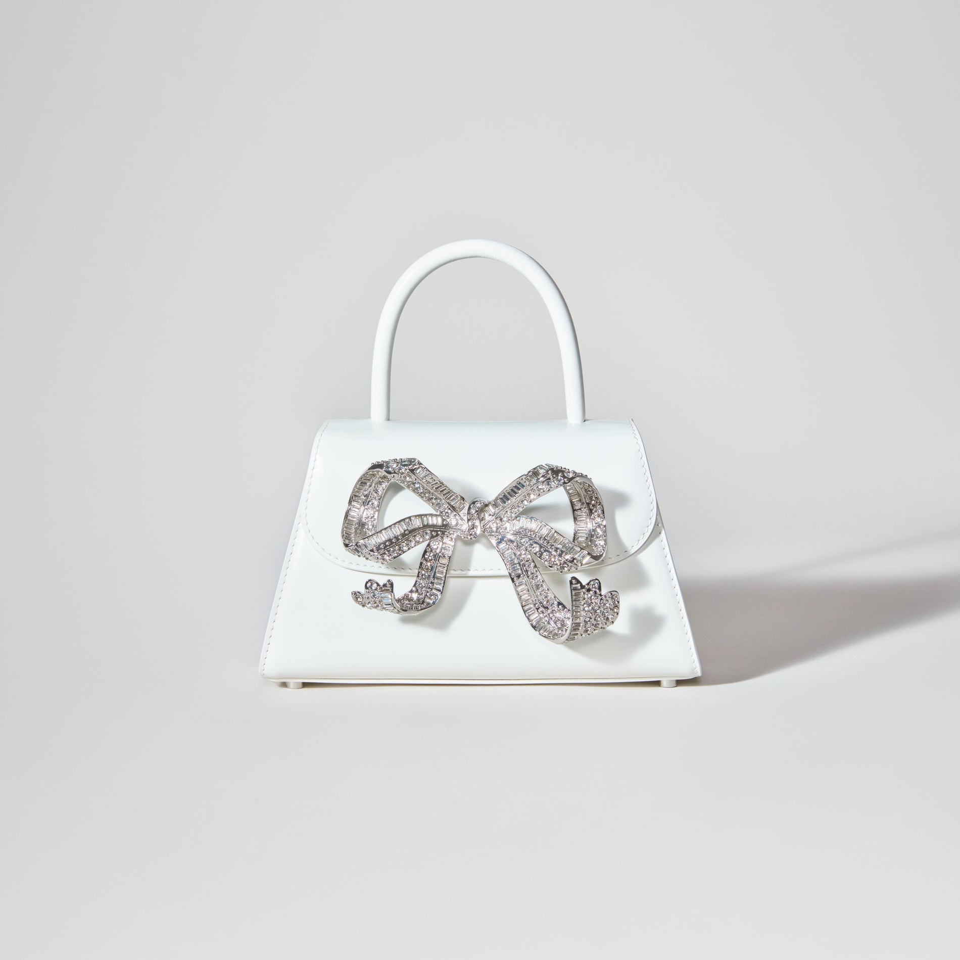 A woman wearing the The Bow Mini in White with Diamanté