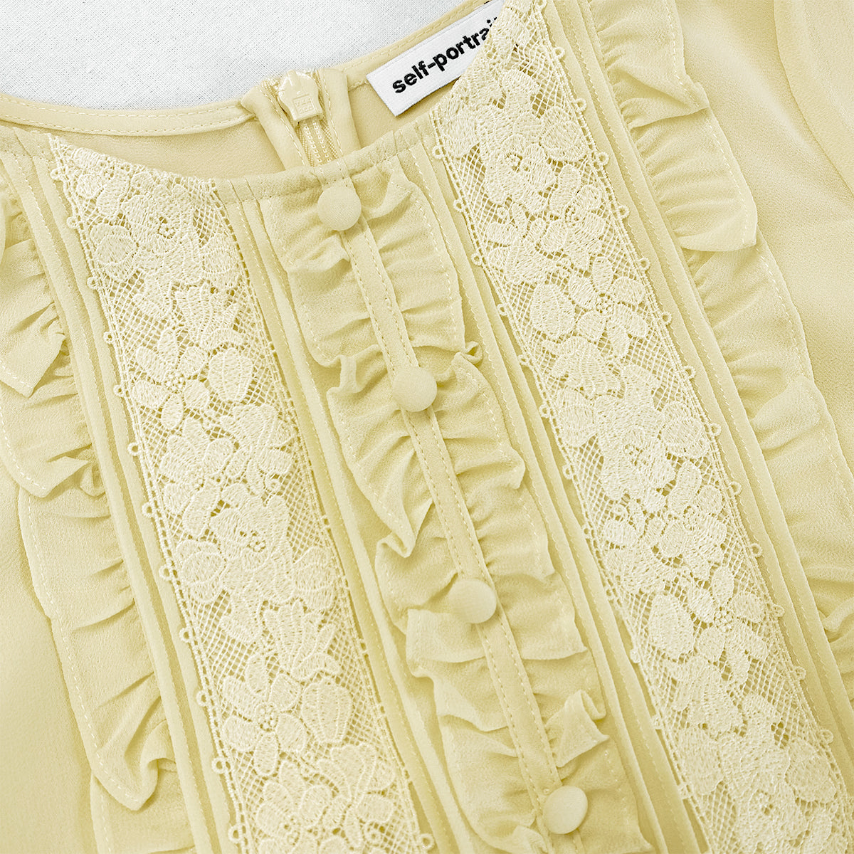 A close up of the fabric for the Yellow Chiffon Ruffle Mini Dress