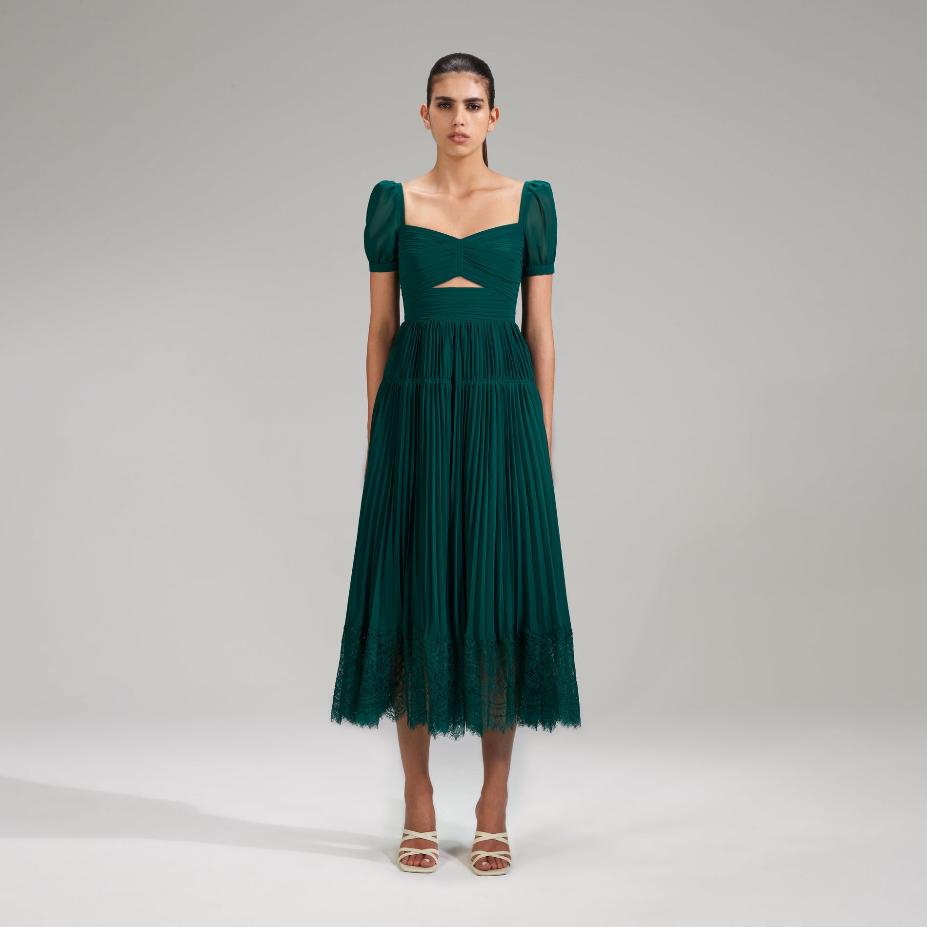 A woman wearing the Deep Green Chiffon Midi Dress