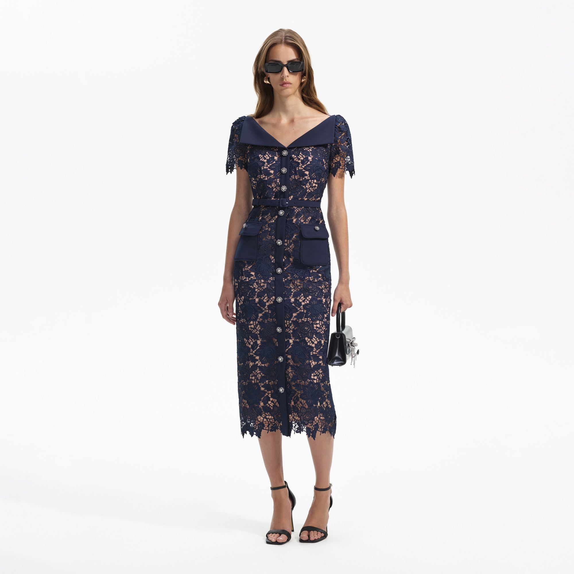 Front view of a woman wearing the Navy Lace Open Neck Midi Dress