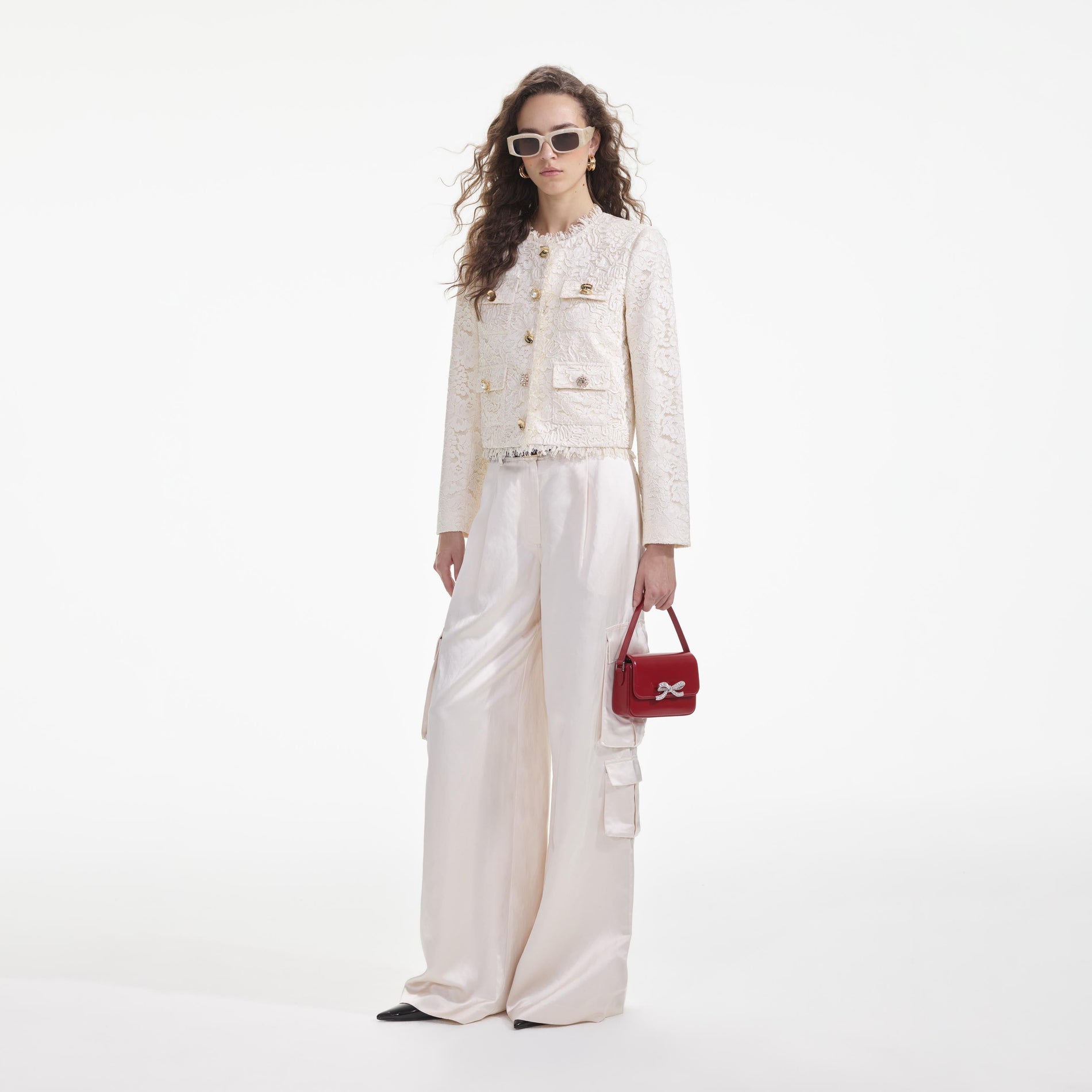 Side view of a woman wearing the Cream Cord Lace Jacket