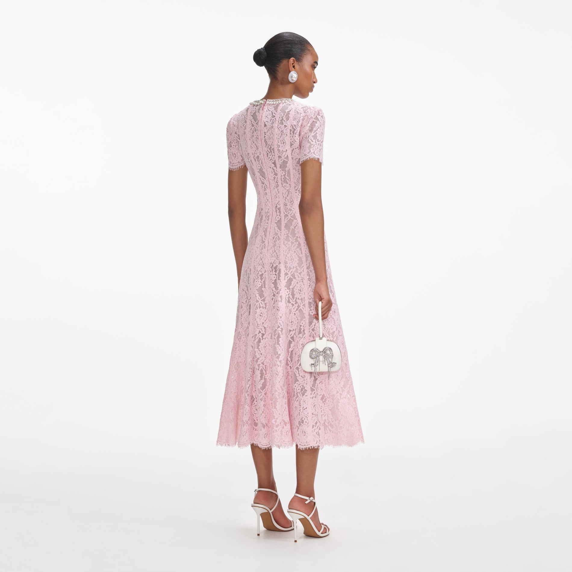 Back view of a woman wearing the Pink Lace Embellished Midi Dress