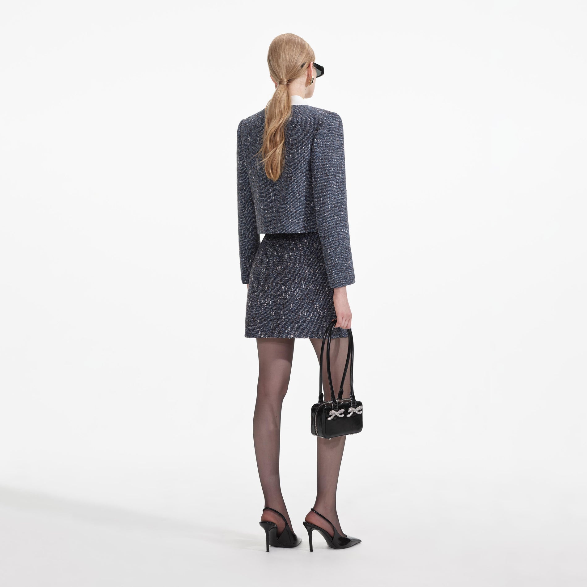 Back view of a woman wearing the Blue Boucle Jacket