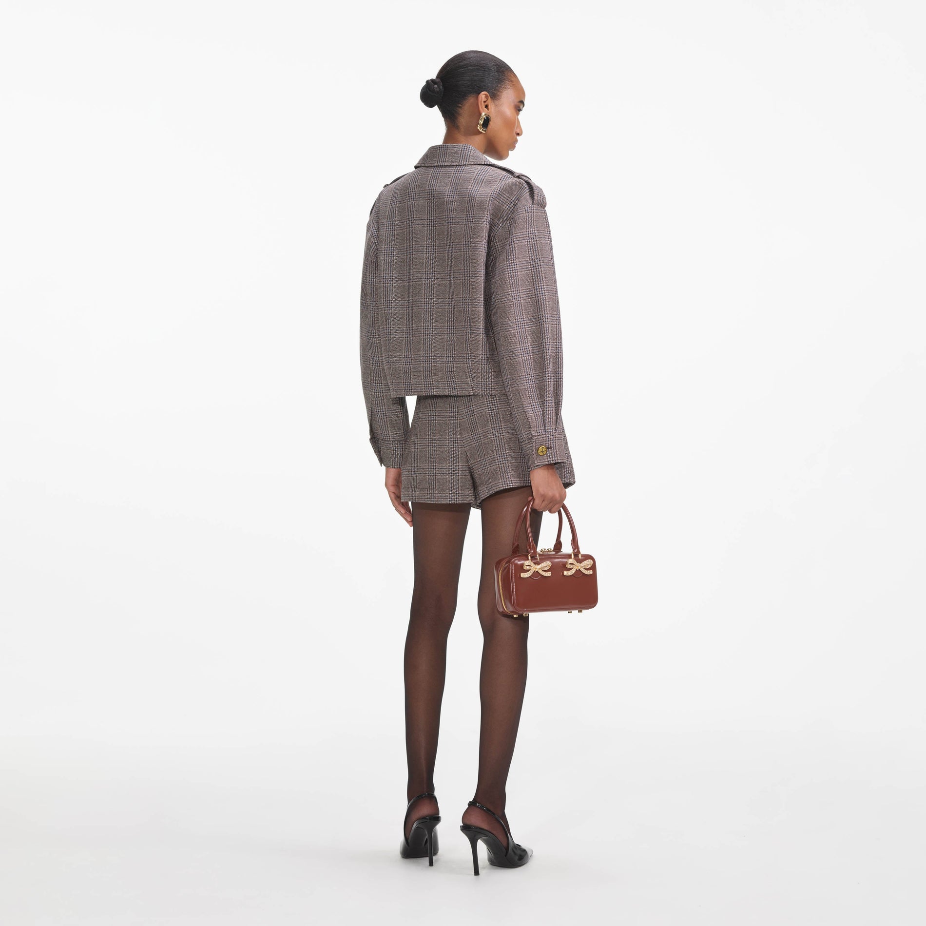 Back view of a woman wearing the Brown Check Mini Skort