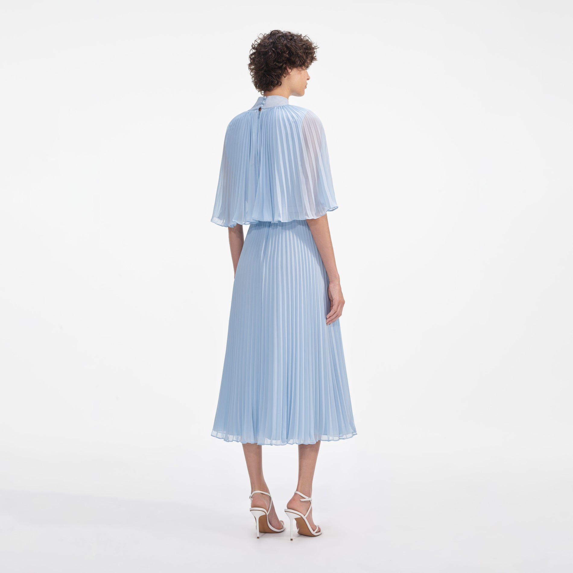 Back view of a woman wearing the Blue Chiffon Cape Midi Dress