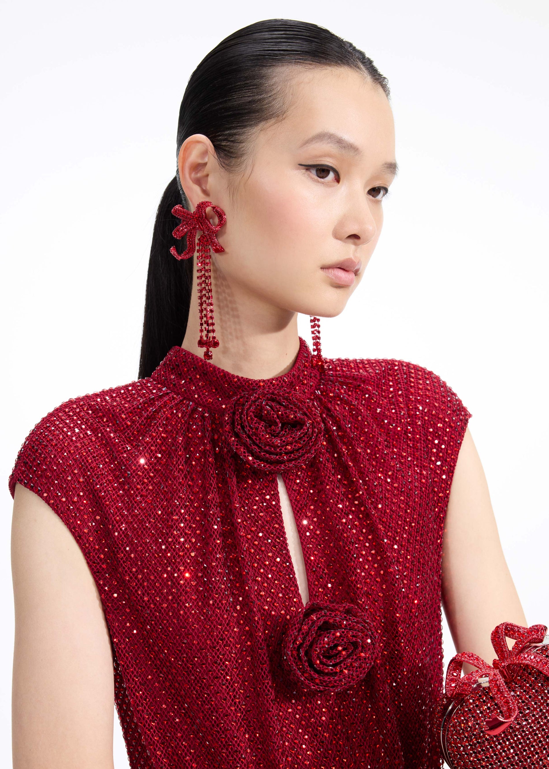 Back view of a woman wearing the Red Bow Diamante Earrings