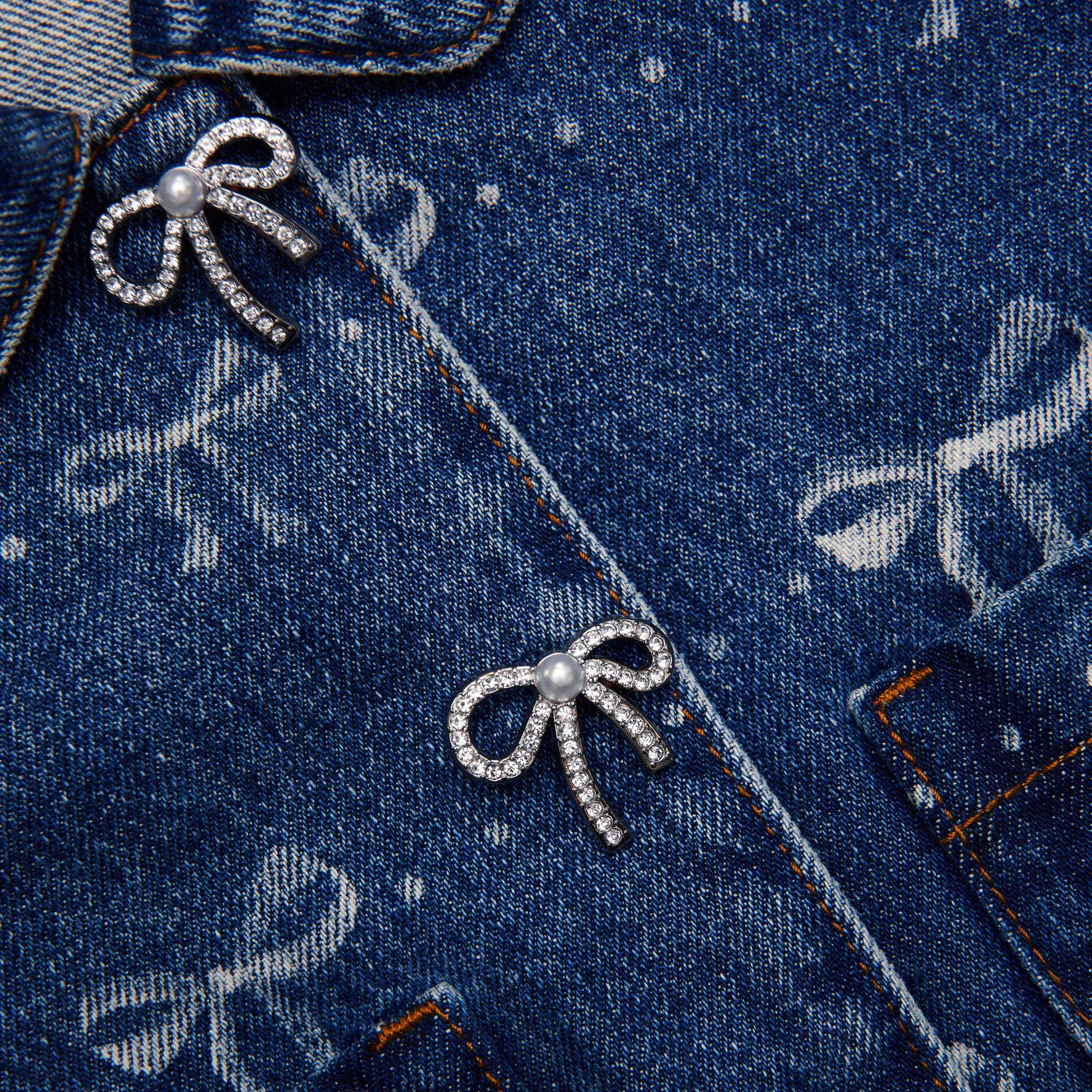 Back view of a woman wearing the Denim Bow Print Jacket