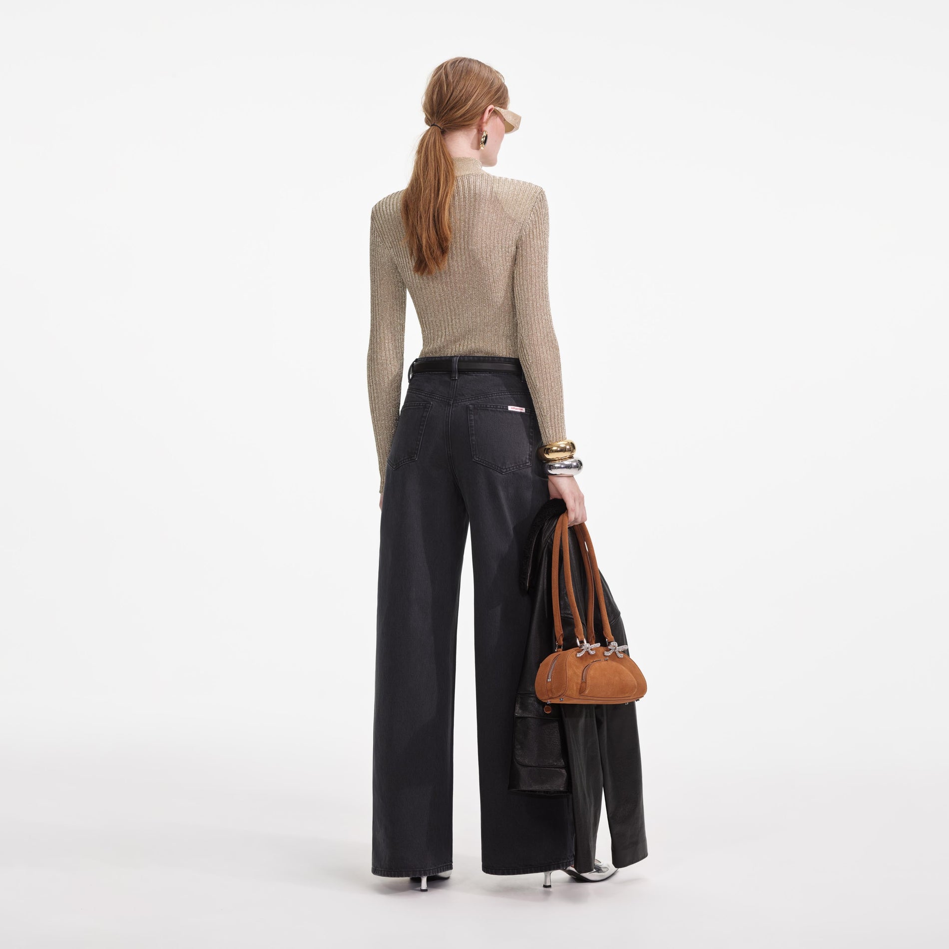 Back view of a woman wearing the Grey Denim Bow Motif Jeans