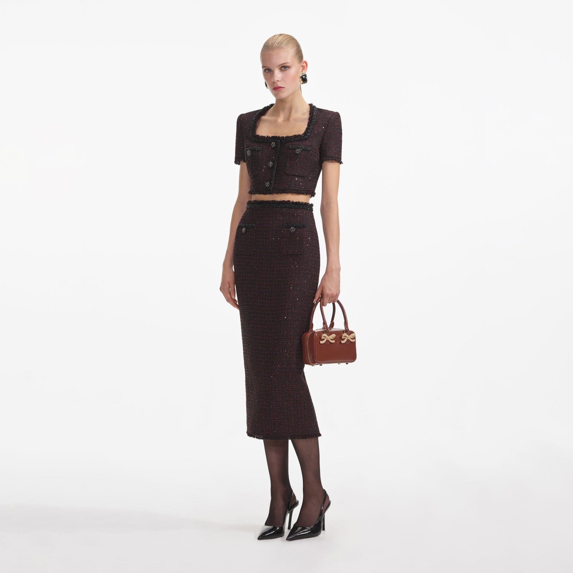 Side view of a woman wearing the Black Metallic Boucle Top