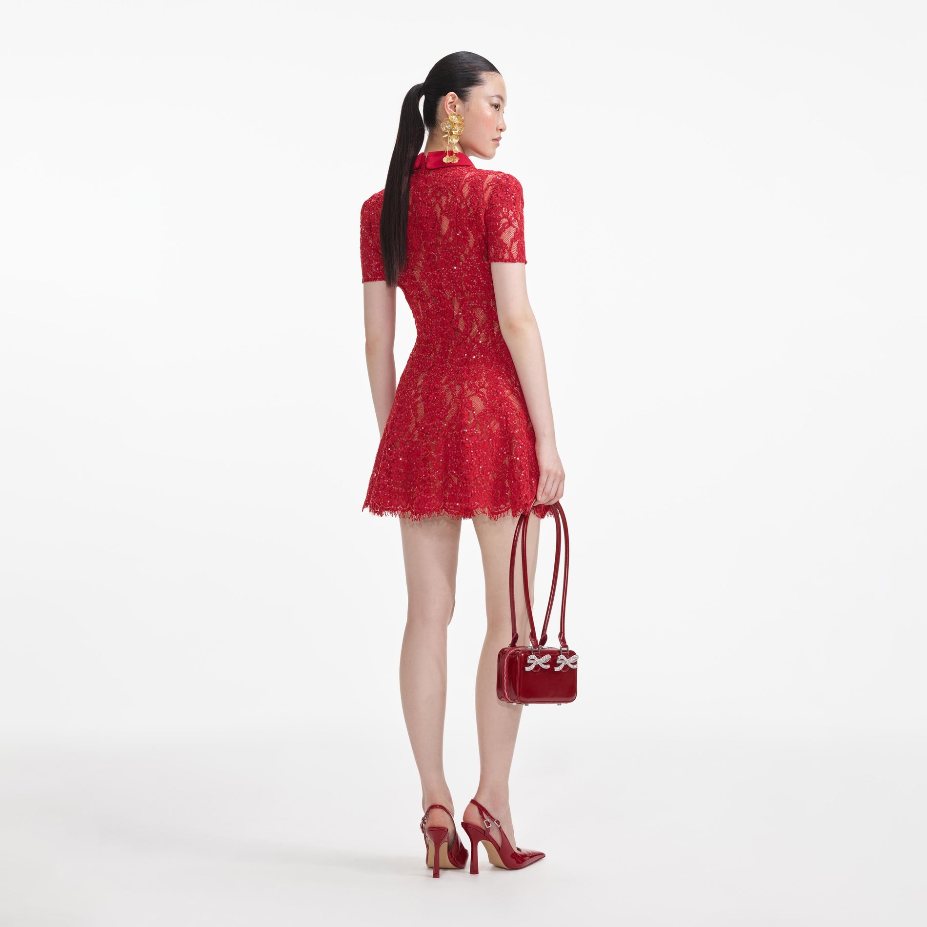 Back view of a woman wearing the Red Sequin Lace Mini Dress