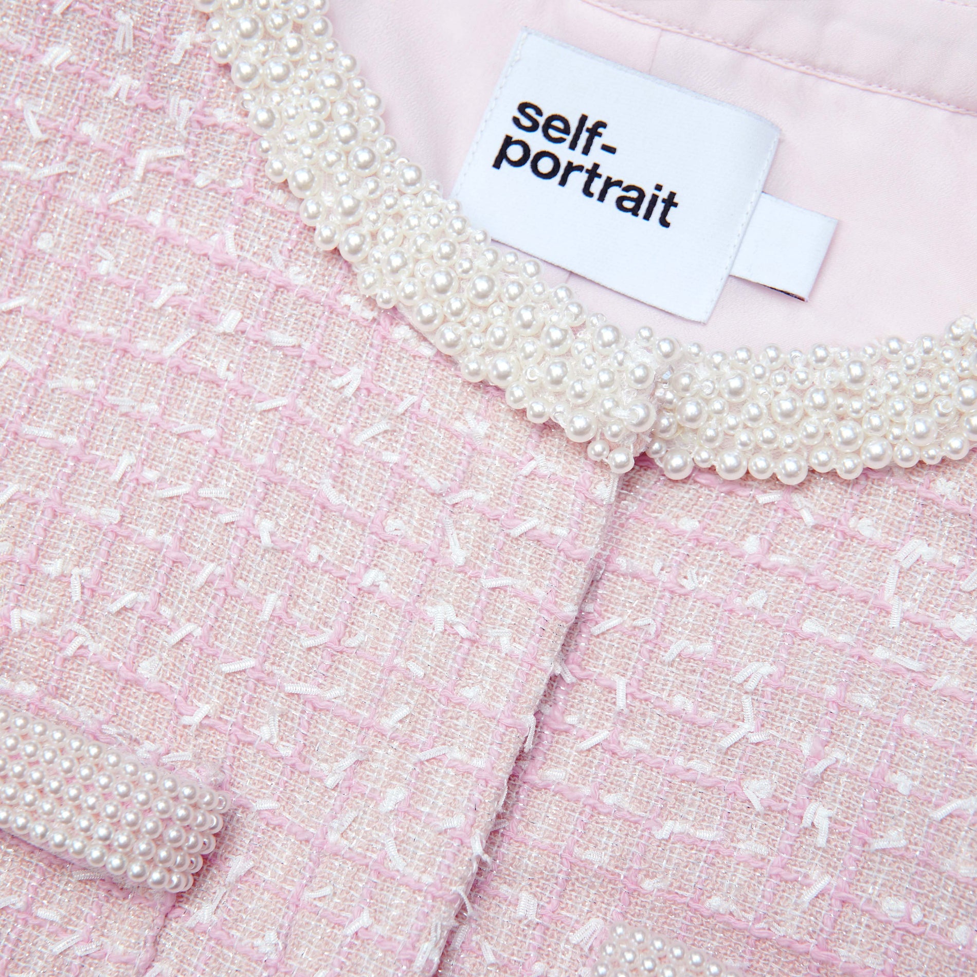 A close up of the fabric for the Pink Boucle Pearl Trim Jacket