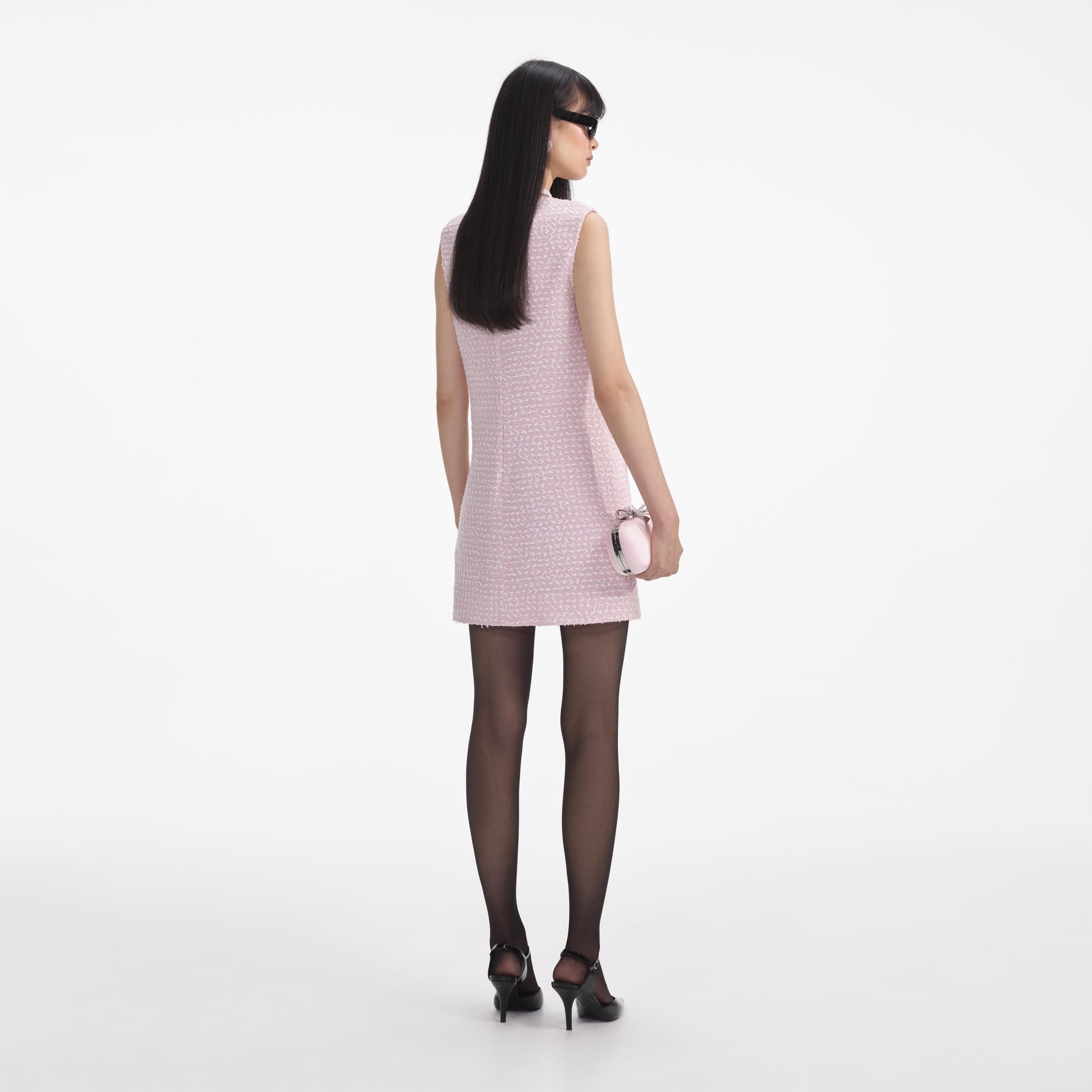 Back view of a woman wearing the Pink Boucle Pearl Trim Mini Dress