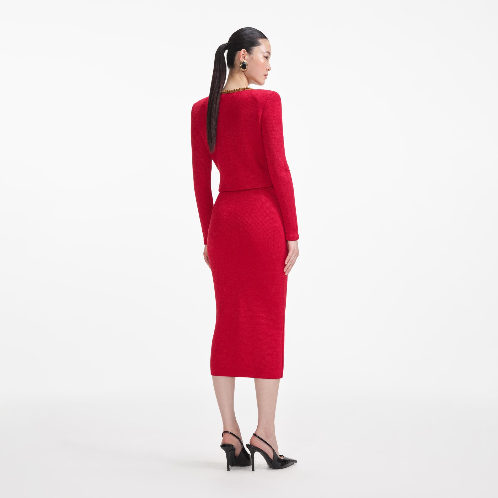 Back view of a woman wearing the Red Textured Knit Corsage Cardigan