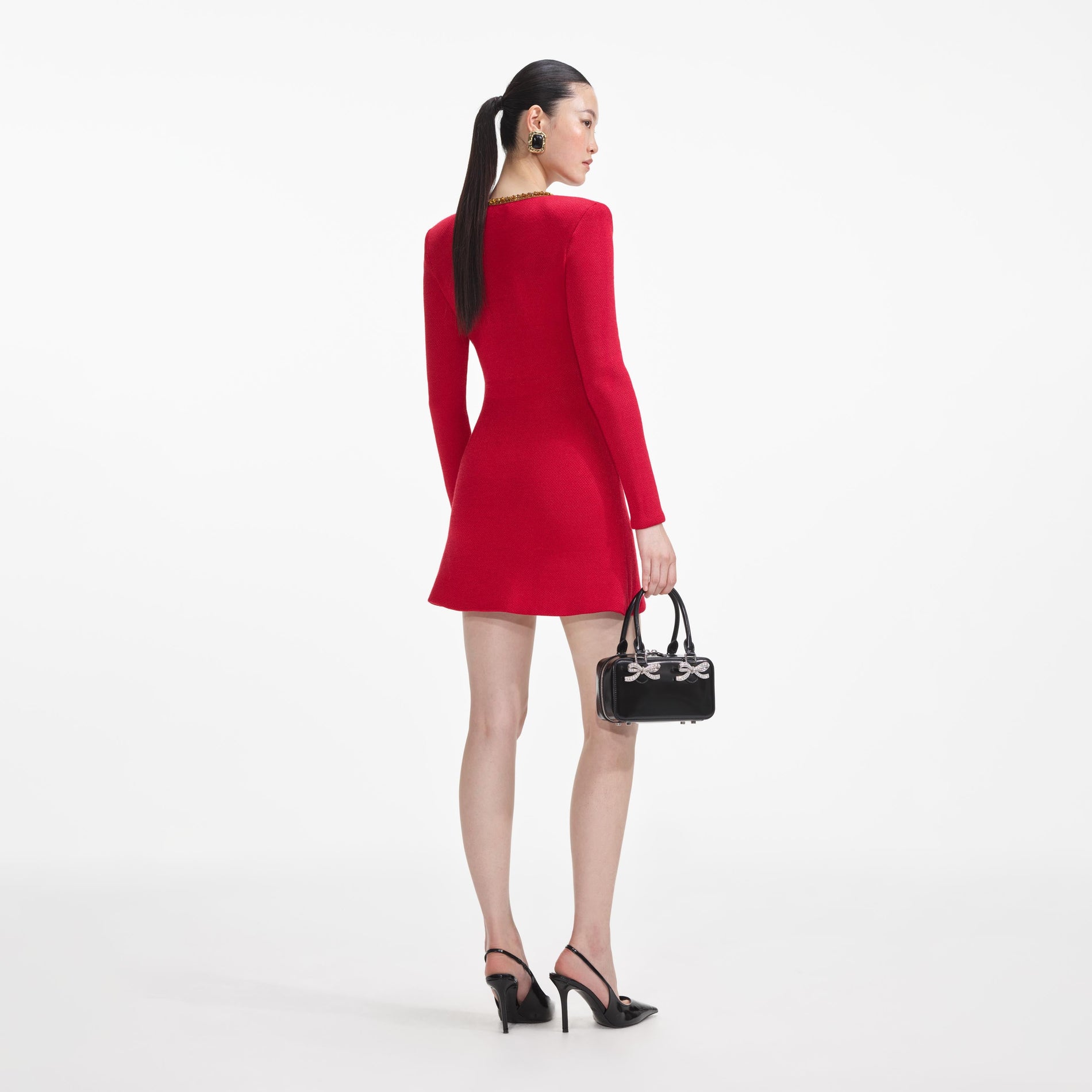 Back view of a woman wearing the Red Textured Knit Corsage Mini Dress