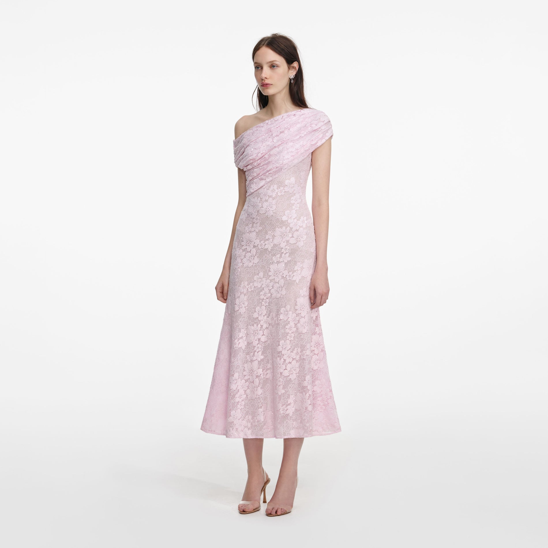 Side view of a woman wearing the Pink Rhinestone Lace Asymmetric Midi Dress