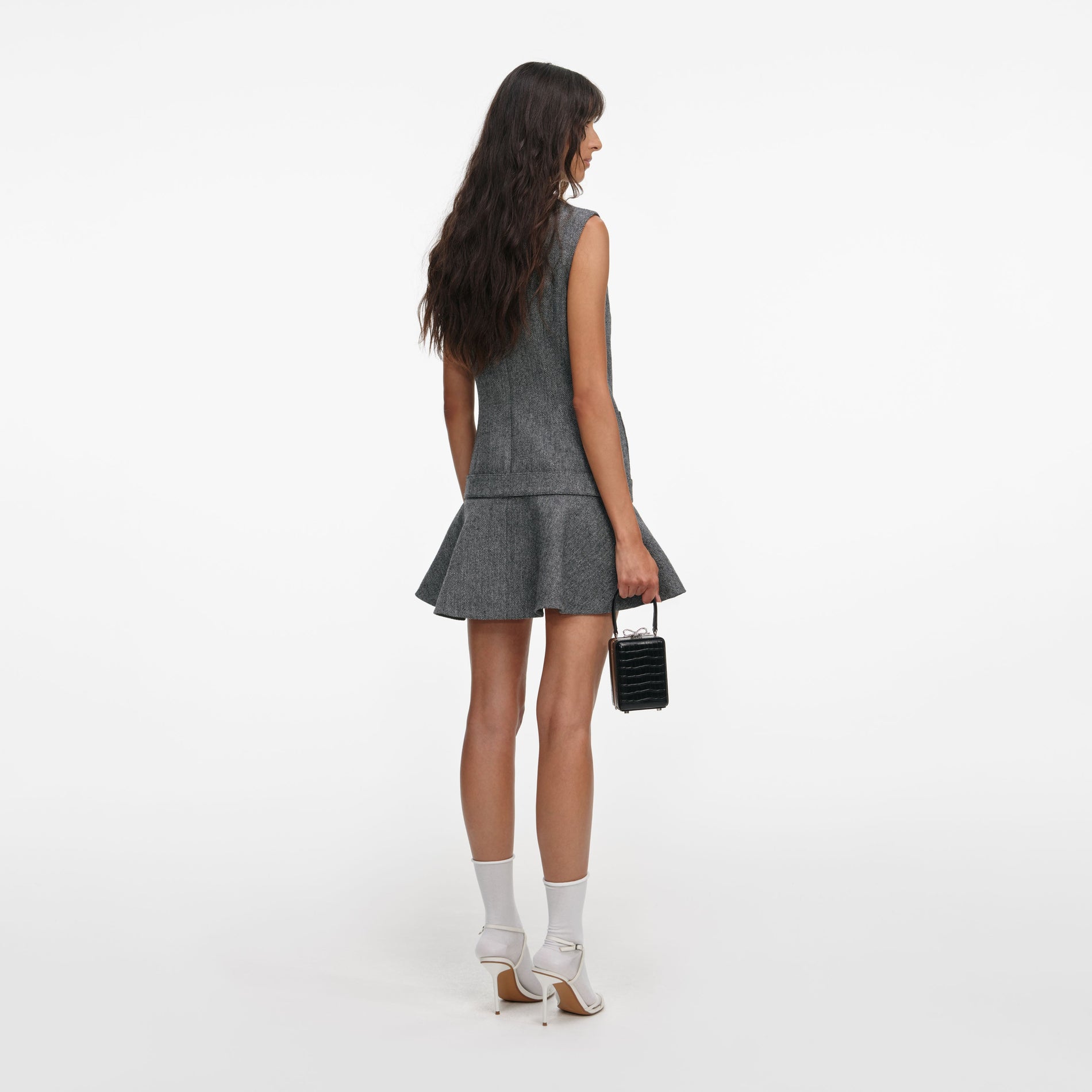 Back view of a woman wearing the Grey Herringbone Flared Mini Dress