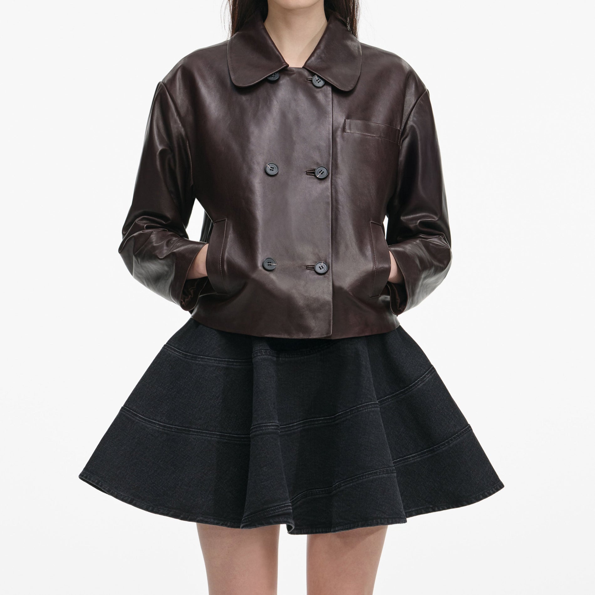 A close up of a woman wearing the Brown Cropped Leather Jacket