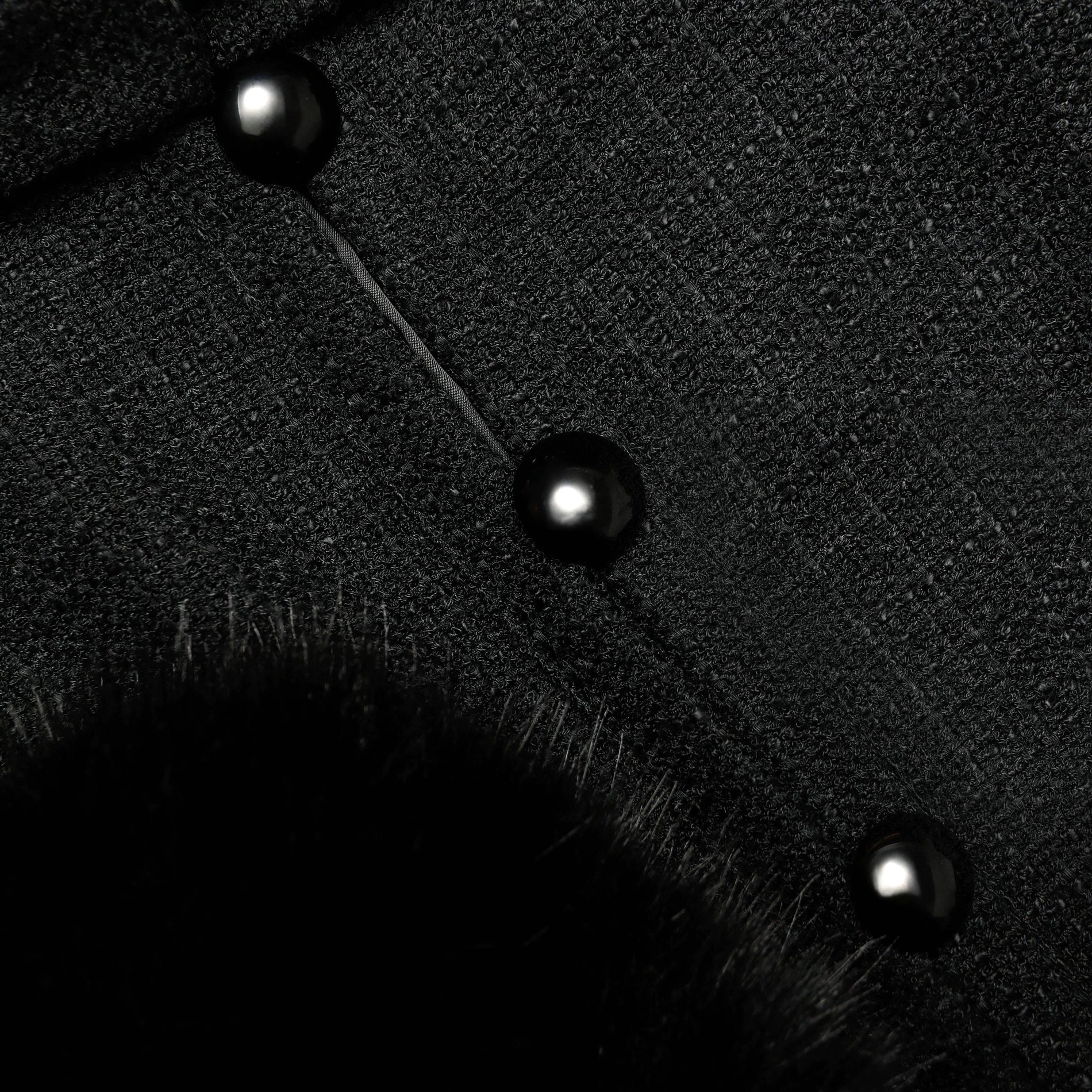 A close up of the fabric for the Black Boucle Faux Fur Cuff Jacket