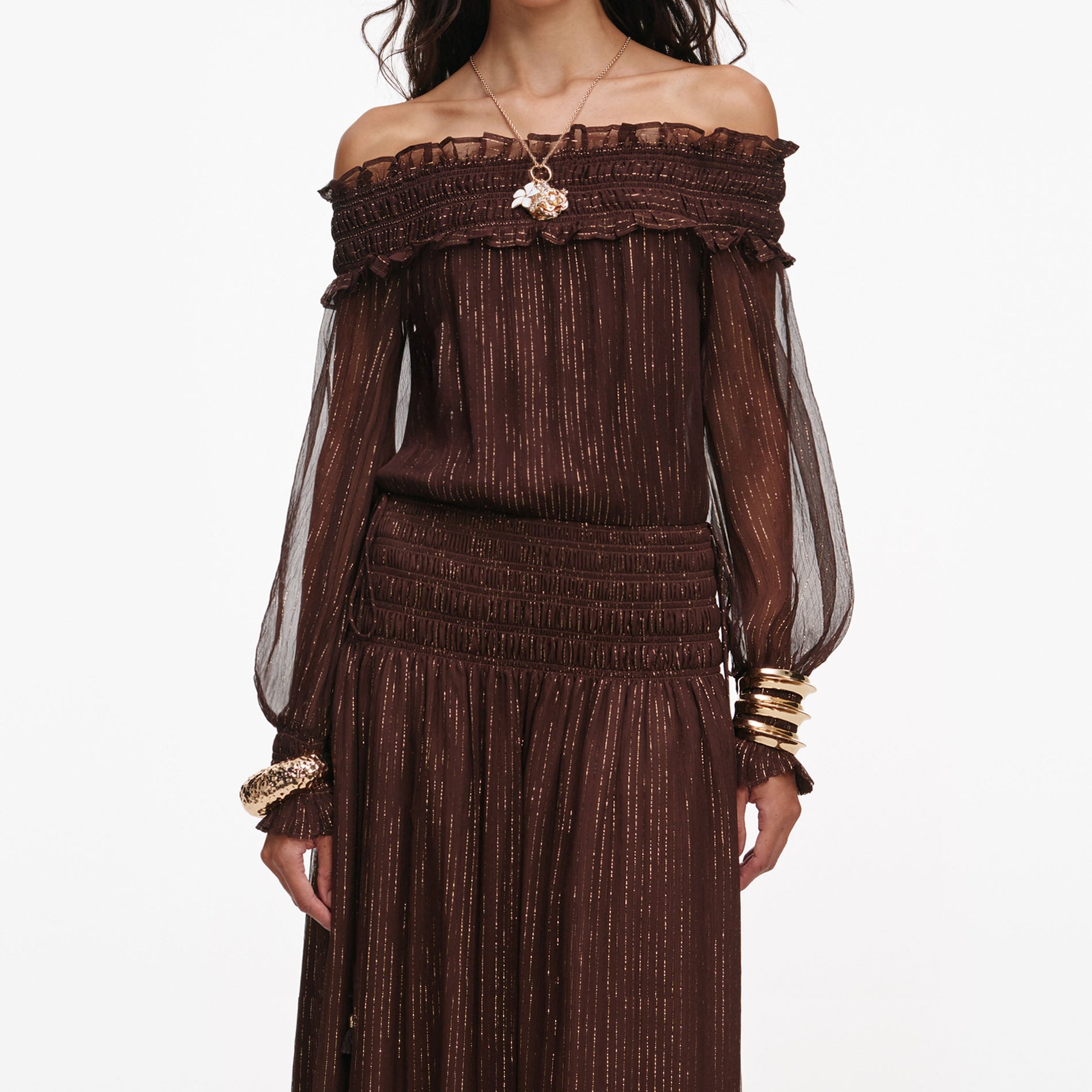 A close up of a woman wearing the Brown Georgette Maxi Dress