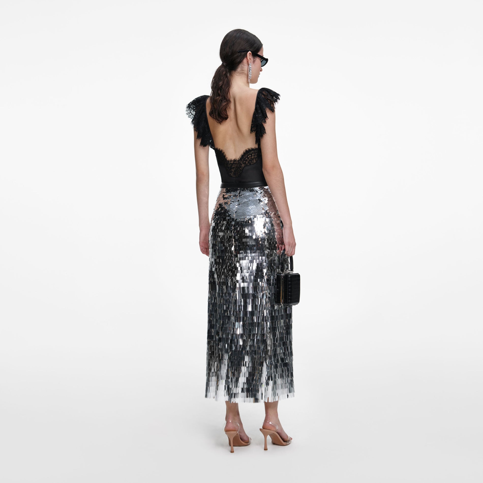 Back view of a woman wearing the Silver Gradient Sequin Midi Skirt