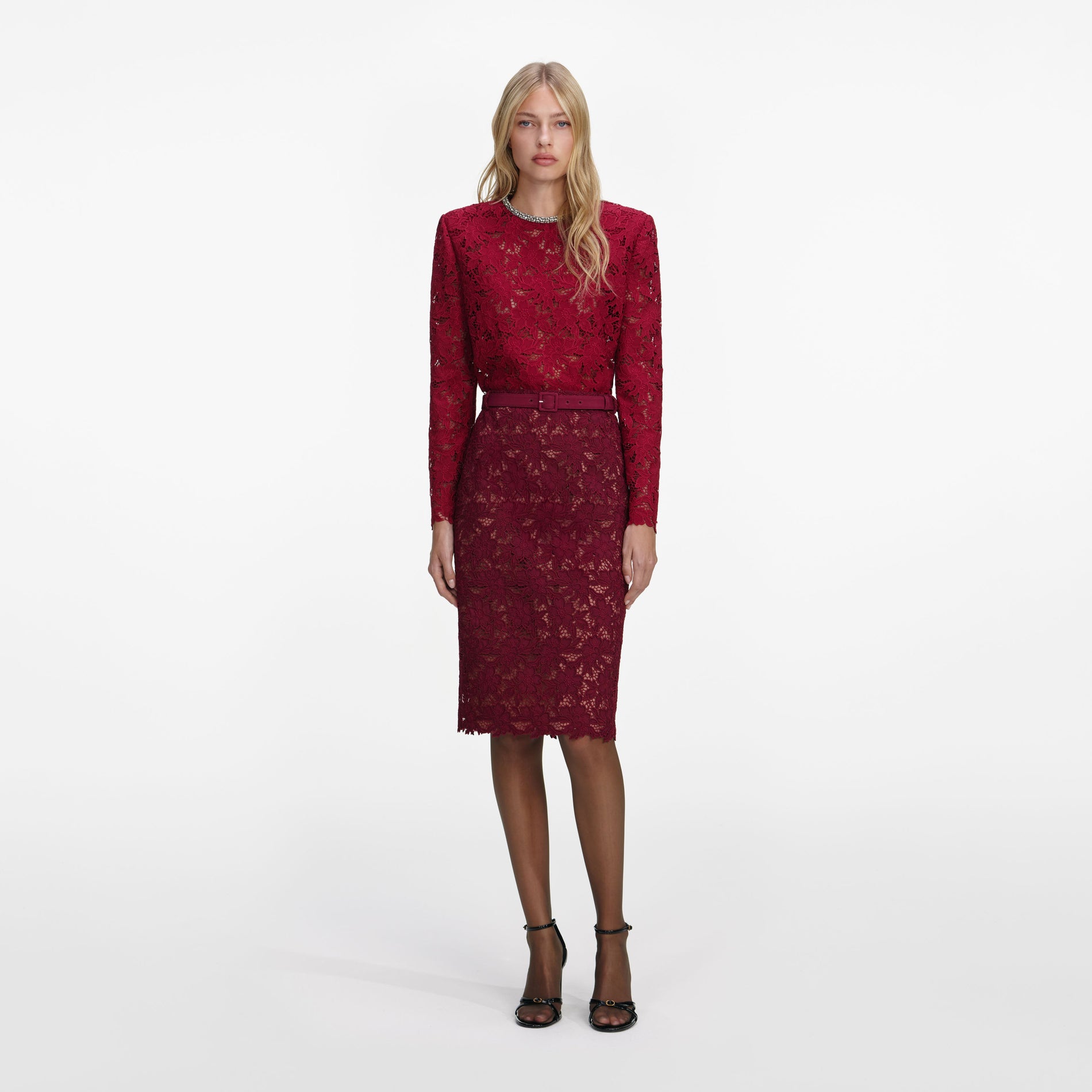 A close up of a woman wearing the Burgundy Guipure Lace Midi Skirt