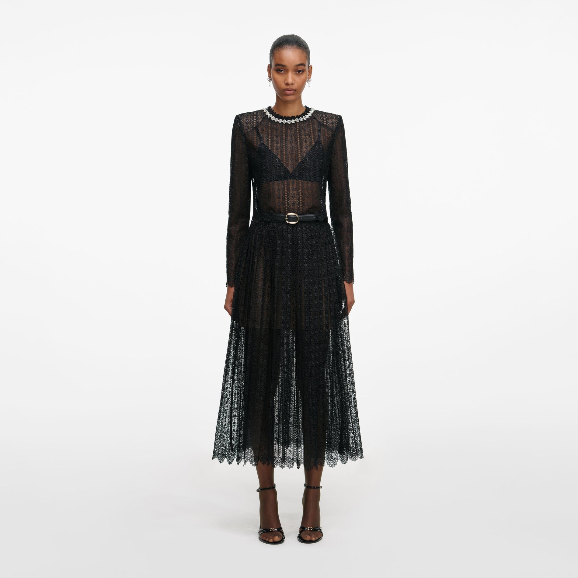 Front view of a woman wearing the Black Organza Lace Midi Skirt