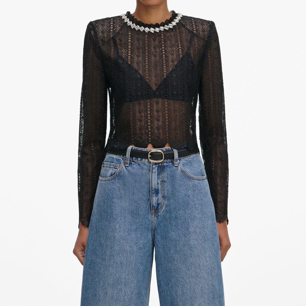 A close up of a woman wearing the Black Organza Lace Top