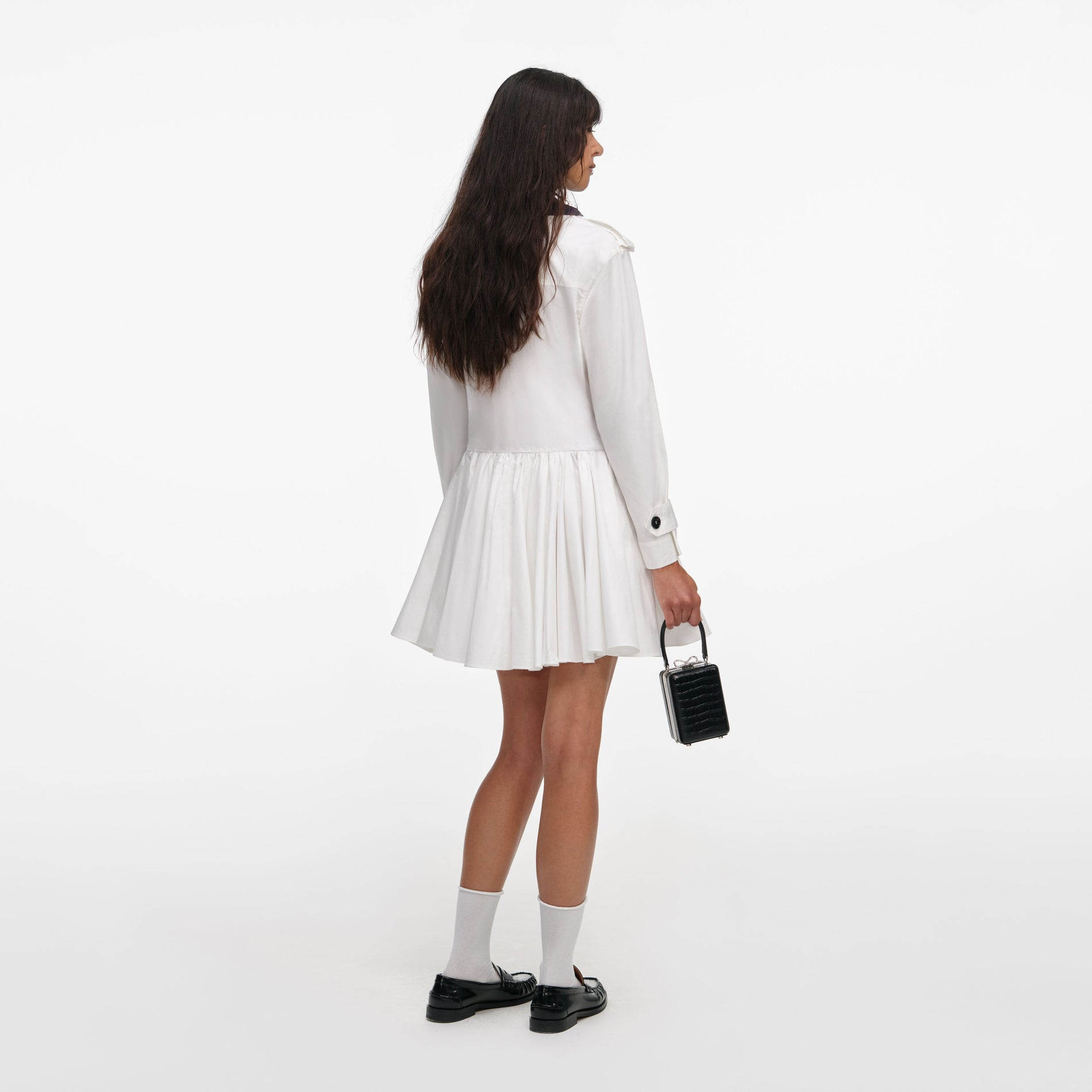 Back view of a woman wearing the White Cotton Double Breasted Mini Dress
