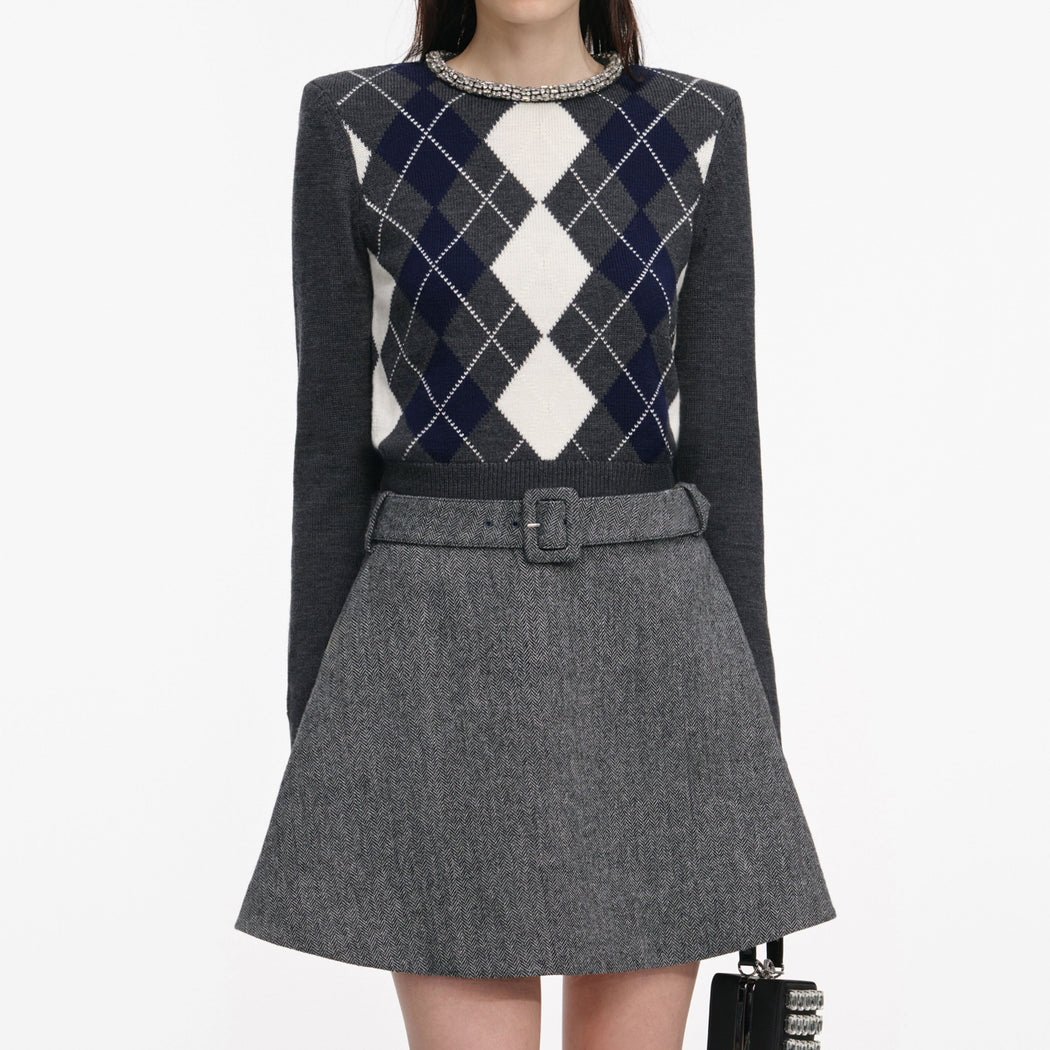A close up of a woman wearing the Grey Herringbone Flared Mini Skirt