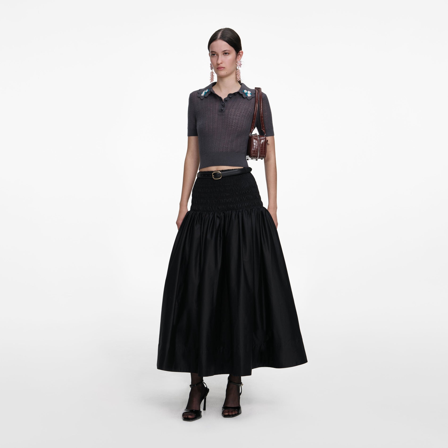 Side view of a woman wearing the Grey Embroidered Pointelle Knit Top