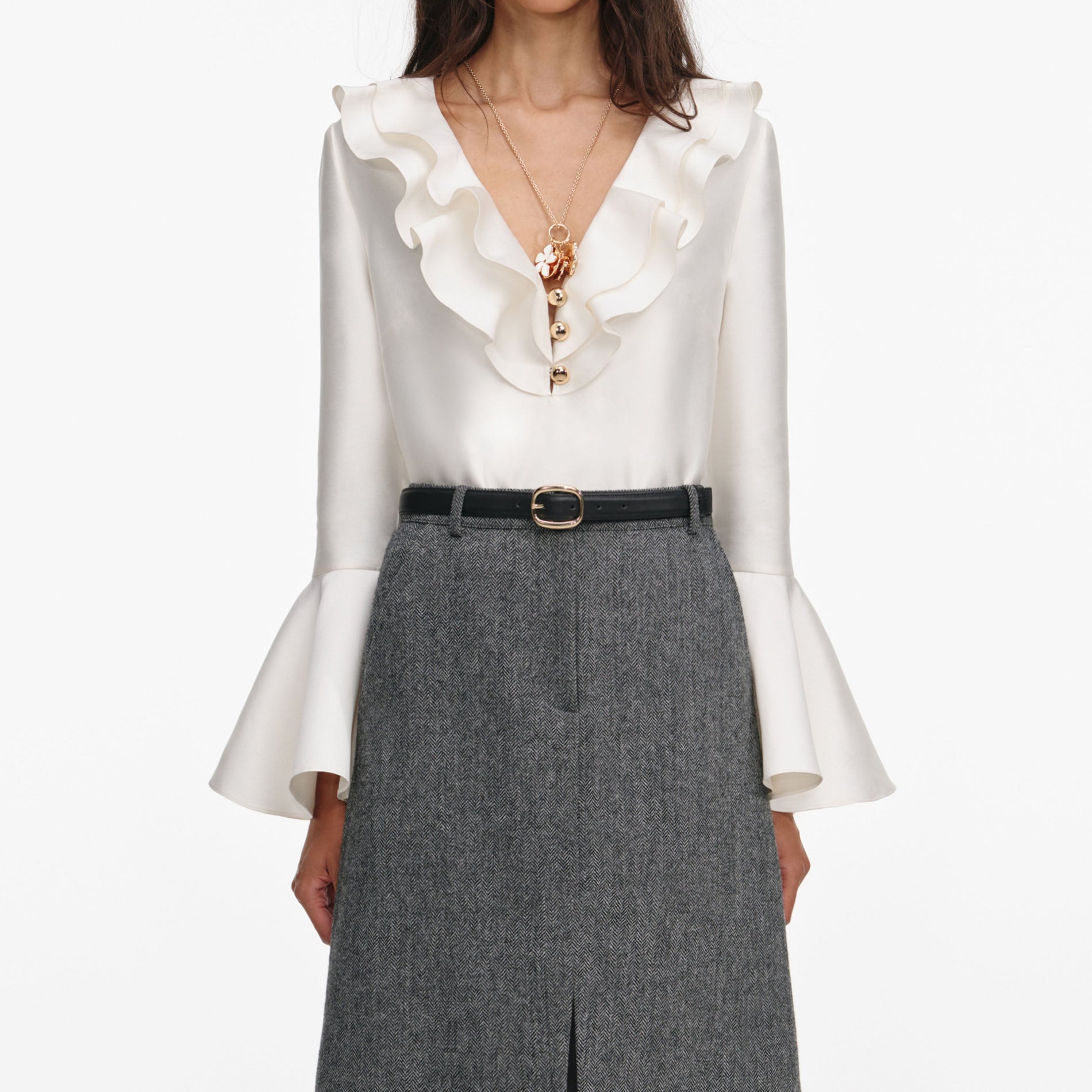 A close up of a woman wearing the Grey Herringbone Midi Skirt