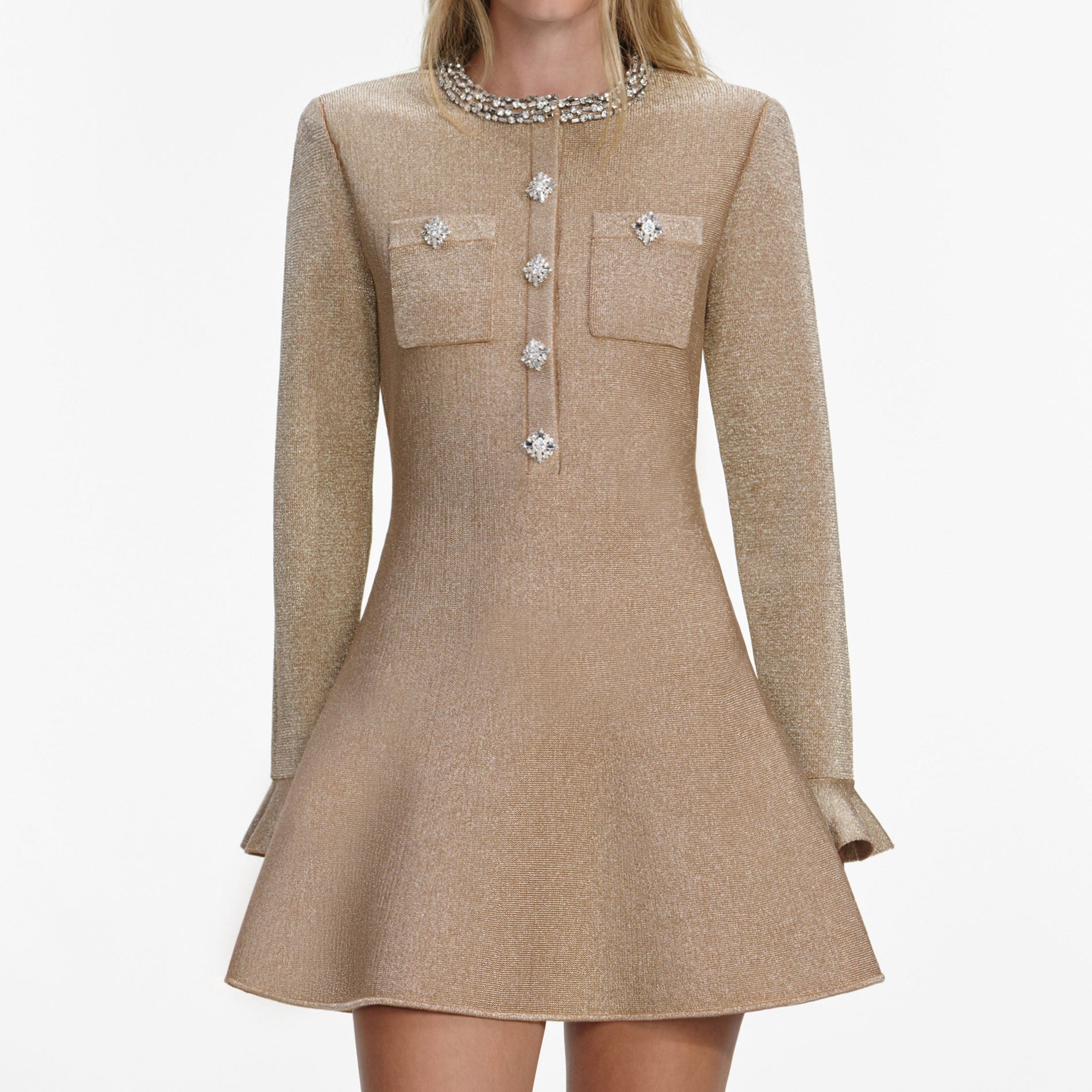 A close up of a woman wearing the Gold Crystal Trim Knit Mini Dress