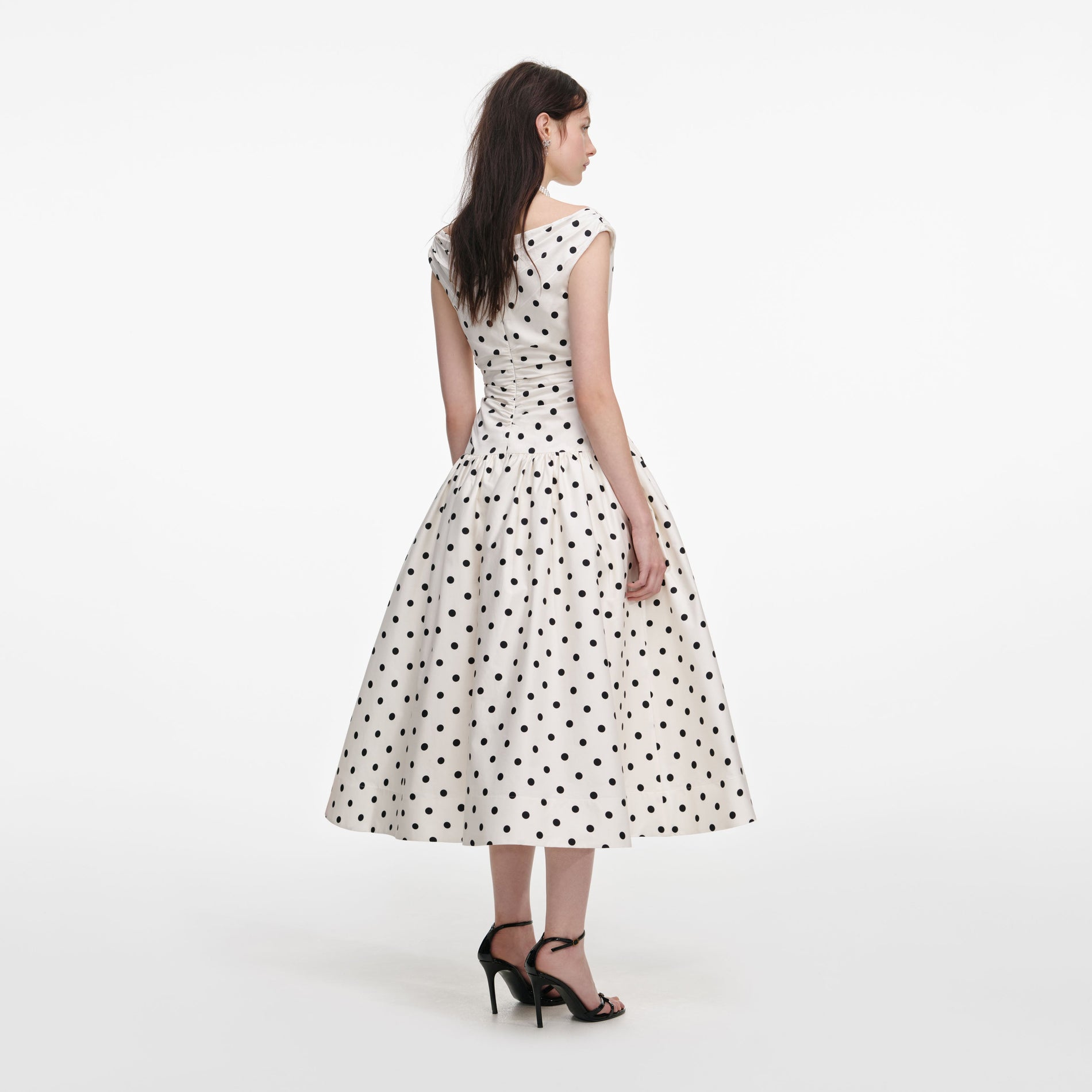 Back view of a woman wearing the Cream Polka Dot Cotton Midi Dress