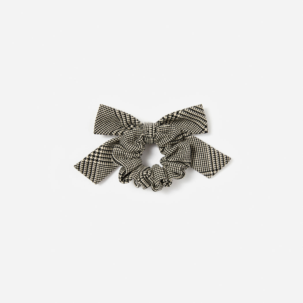 Black and white houndstooth scrunchie with a bow