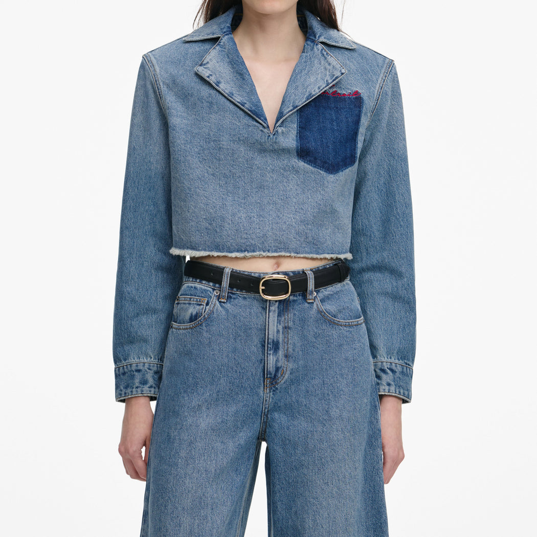 A close up of a woman wearing the Cropped Denim Shirt