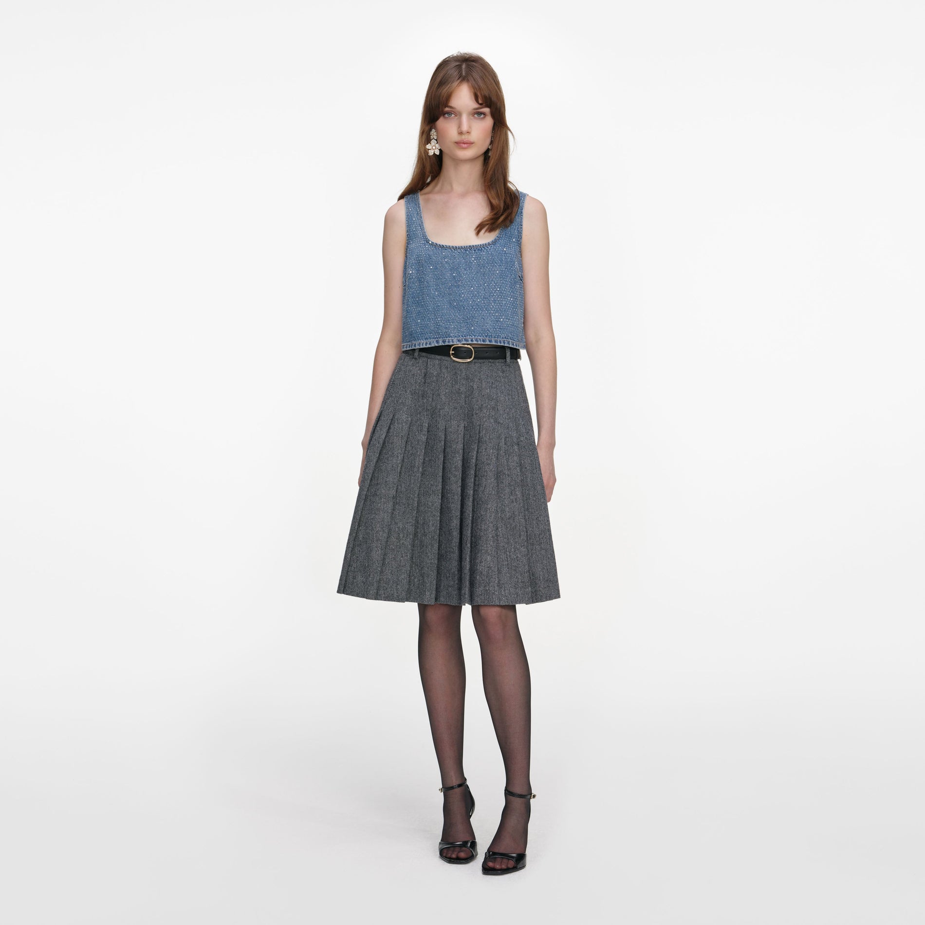 Front view of a woman wearing the Grey Herringbone Pleated Midi Skirt