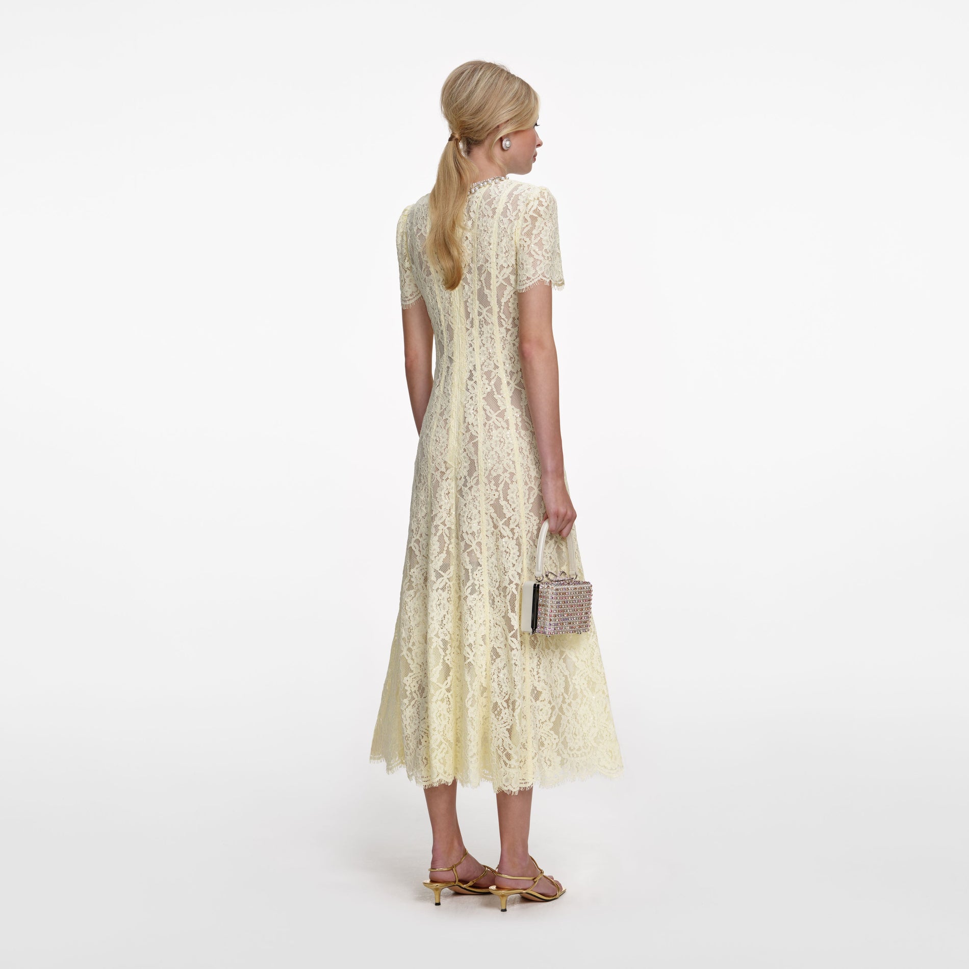 Back view of a woman wearing the Yellow Lace Embellished Midi Dress