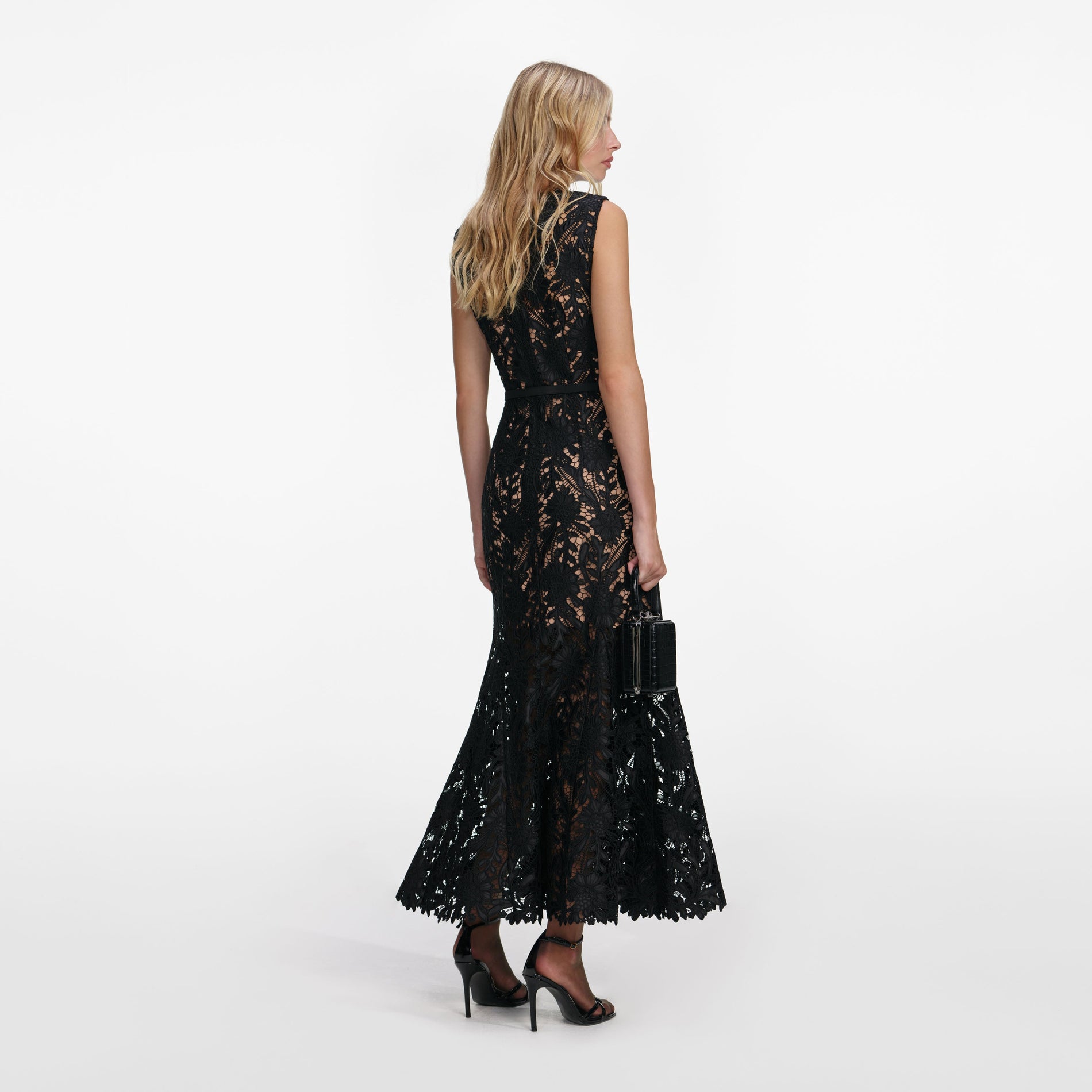 Back view of a woman wearing the Black Guipure Lace Midi Dress