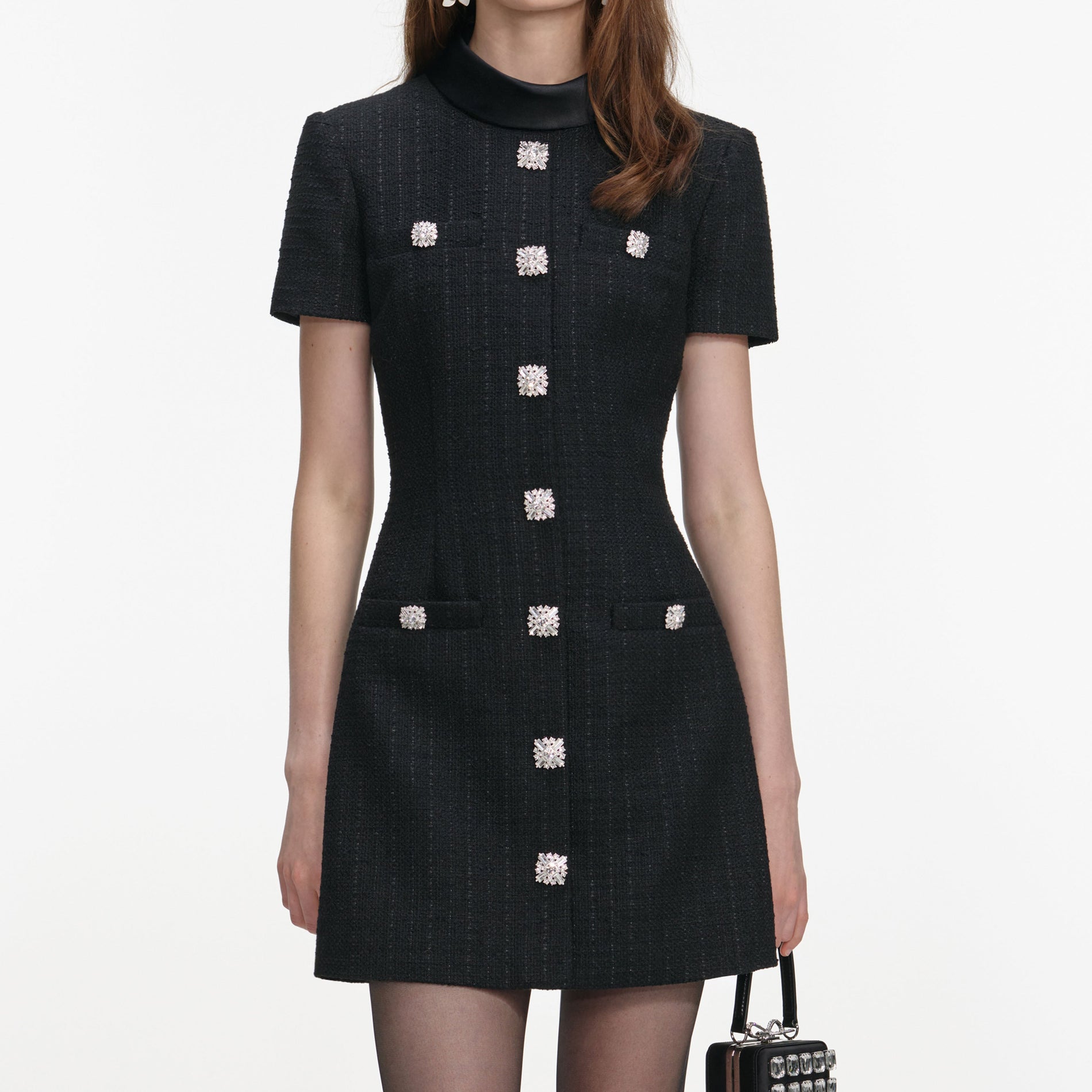 A close up of a woman wearing the Black Boucle Collared Mini Dress