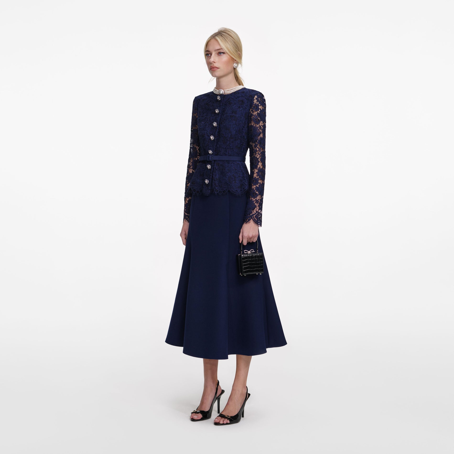 Side view of a woman wearing the Navy Tailored Lace Midi Dress
