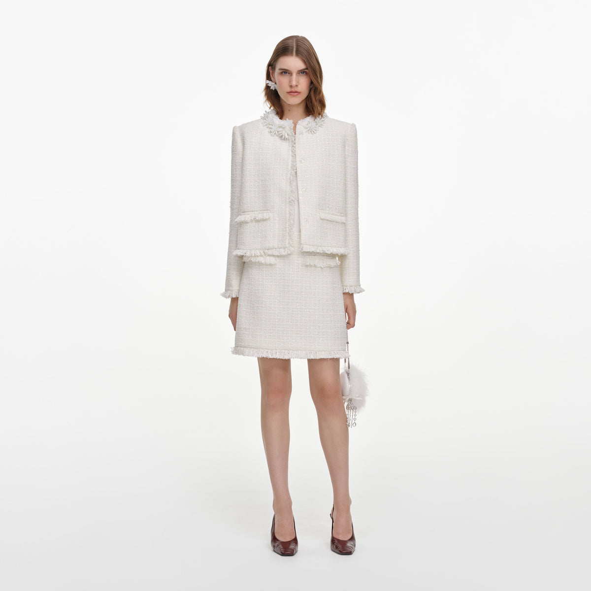 Front view of a woman wearing the Cream Sequin Boucle Mini Skirt