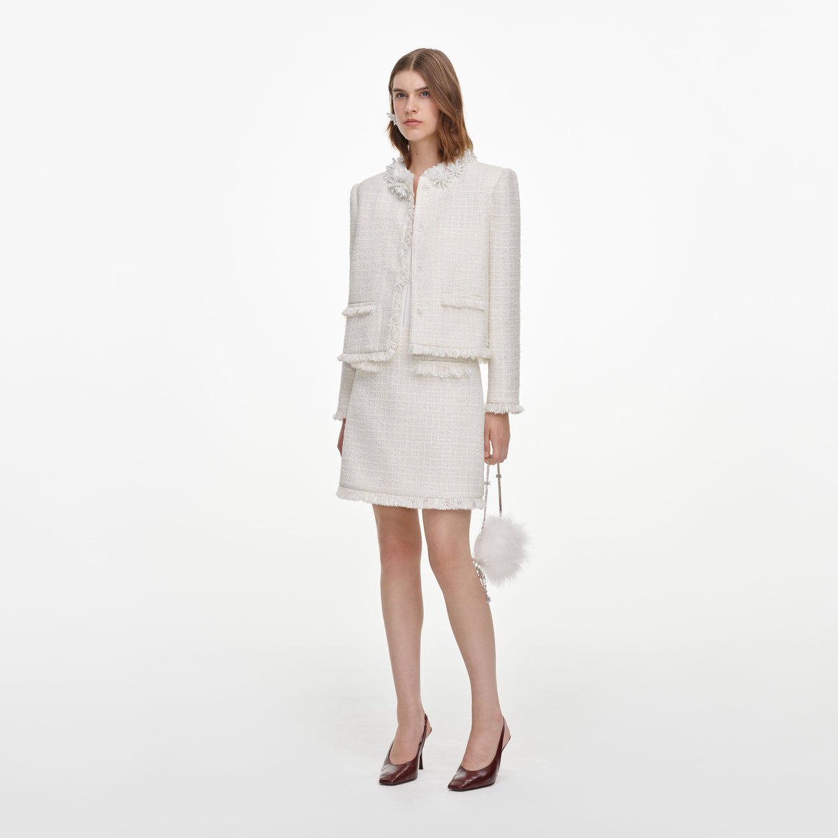 Side view of a woman wearing the Cream Sequin Boucle Mini Skirt