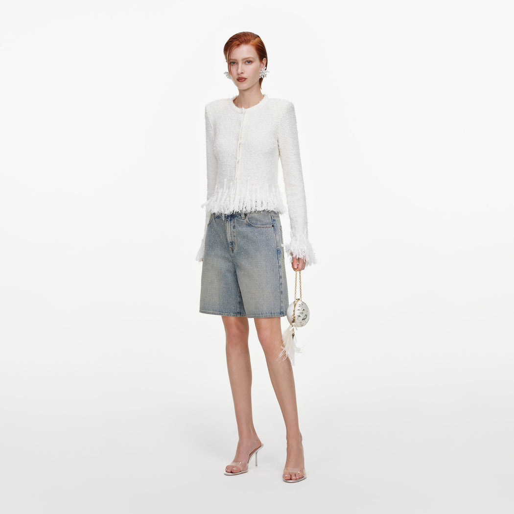 Side view of a woman wearing the White Fringe Knit Cardigan